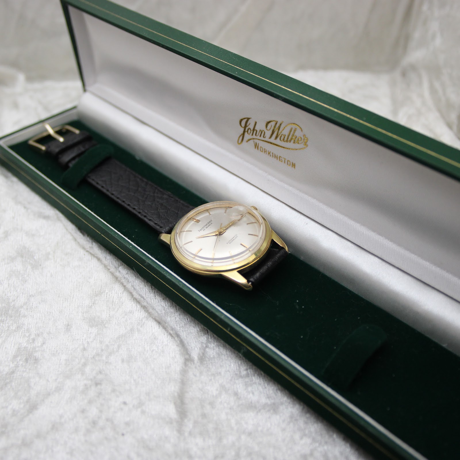 Aristocrat watch displayed in a green 'John Walker Workington' presentation box.