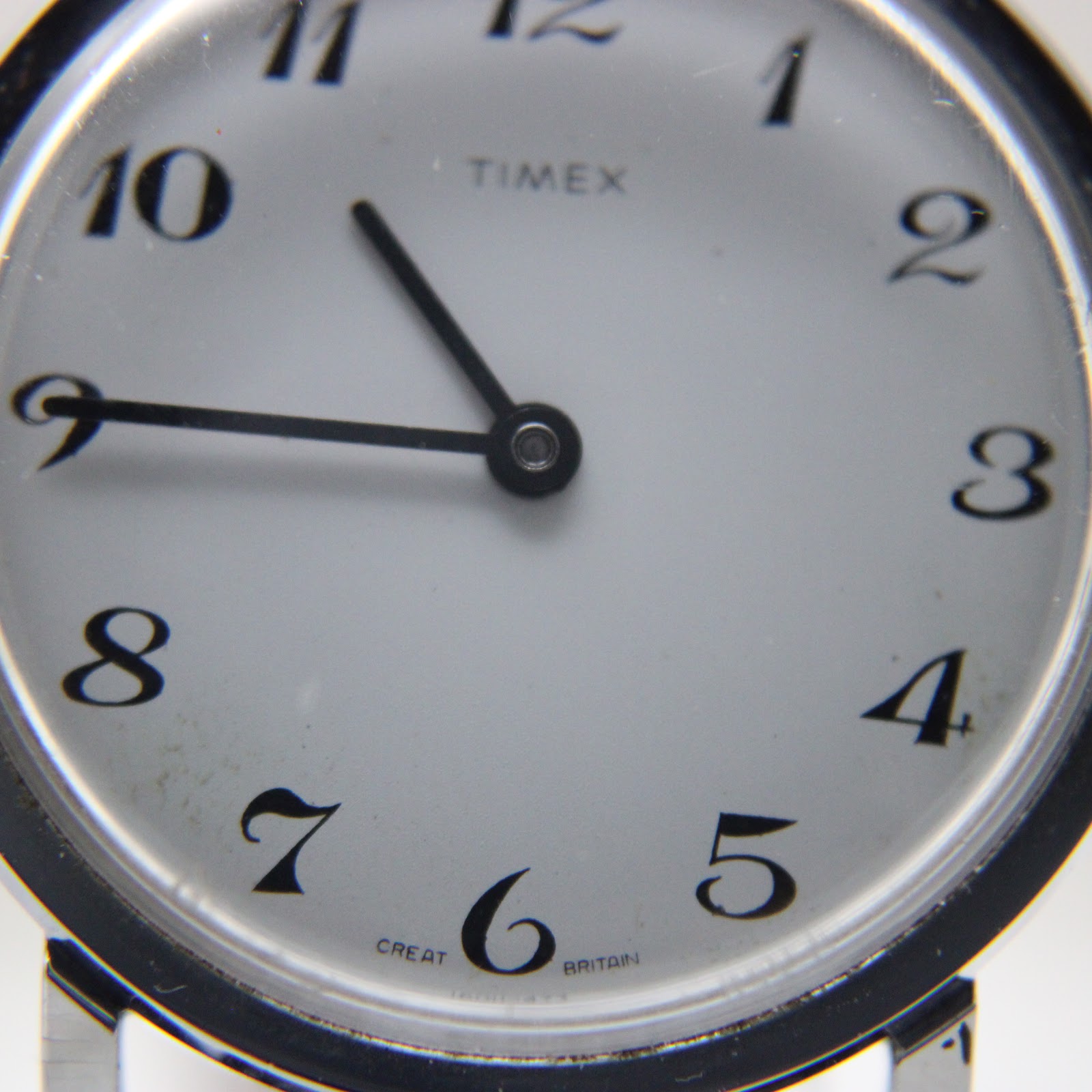 Close-up of the white Timex dial, showing the brand name, Arabic numerals, and 'GREAT BRITAIN' text.