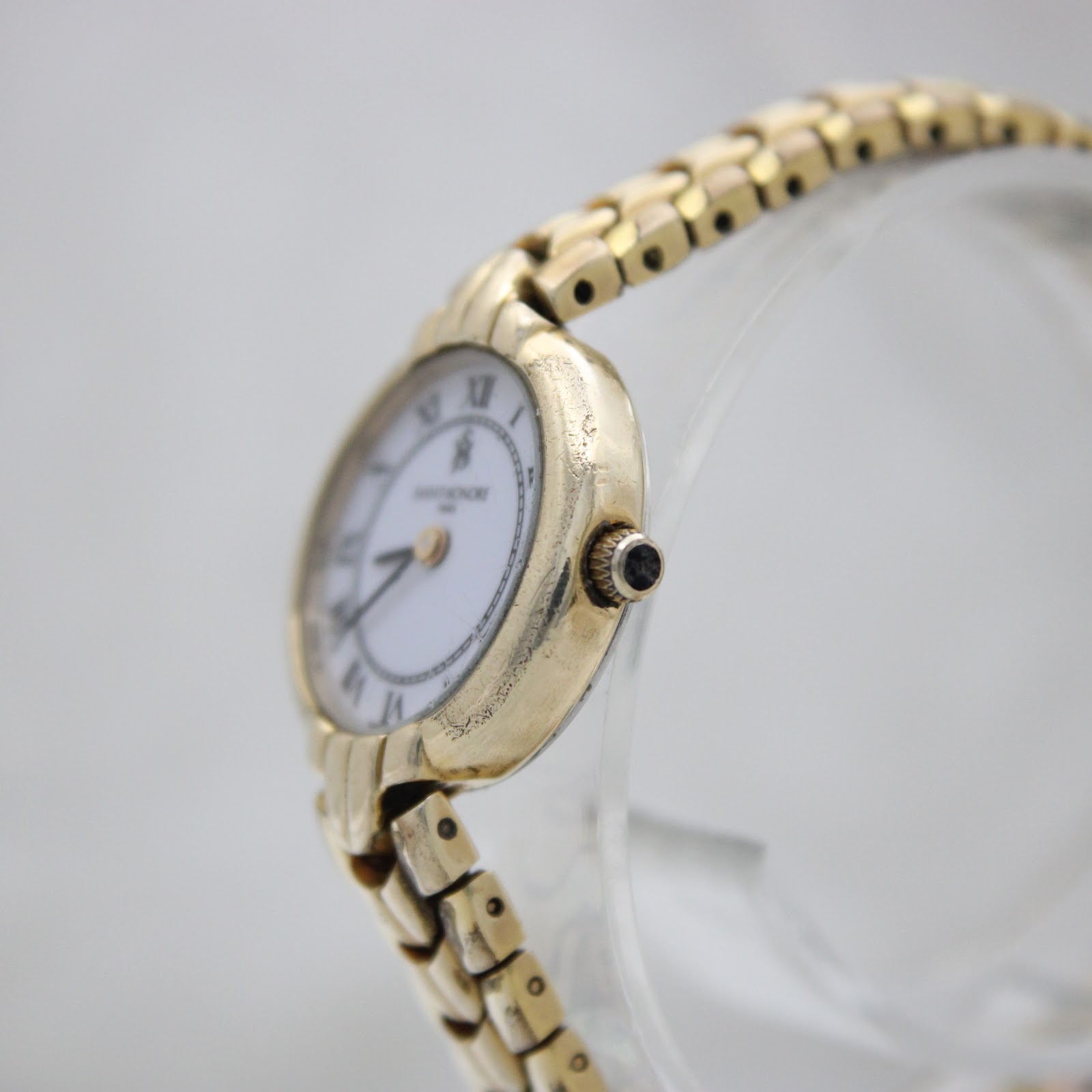 Angled side view of the Saint-Honoré Paris watch showing the gold-tone case and crown detail