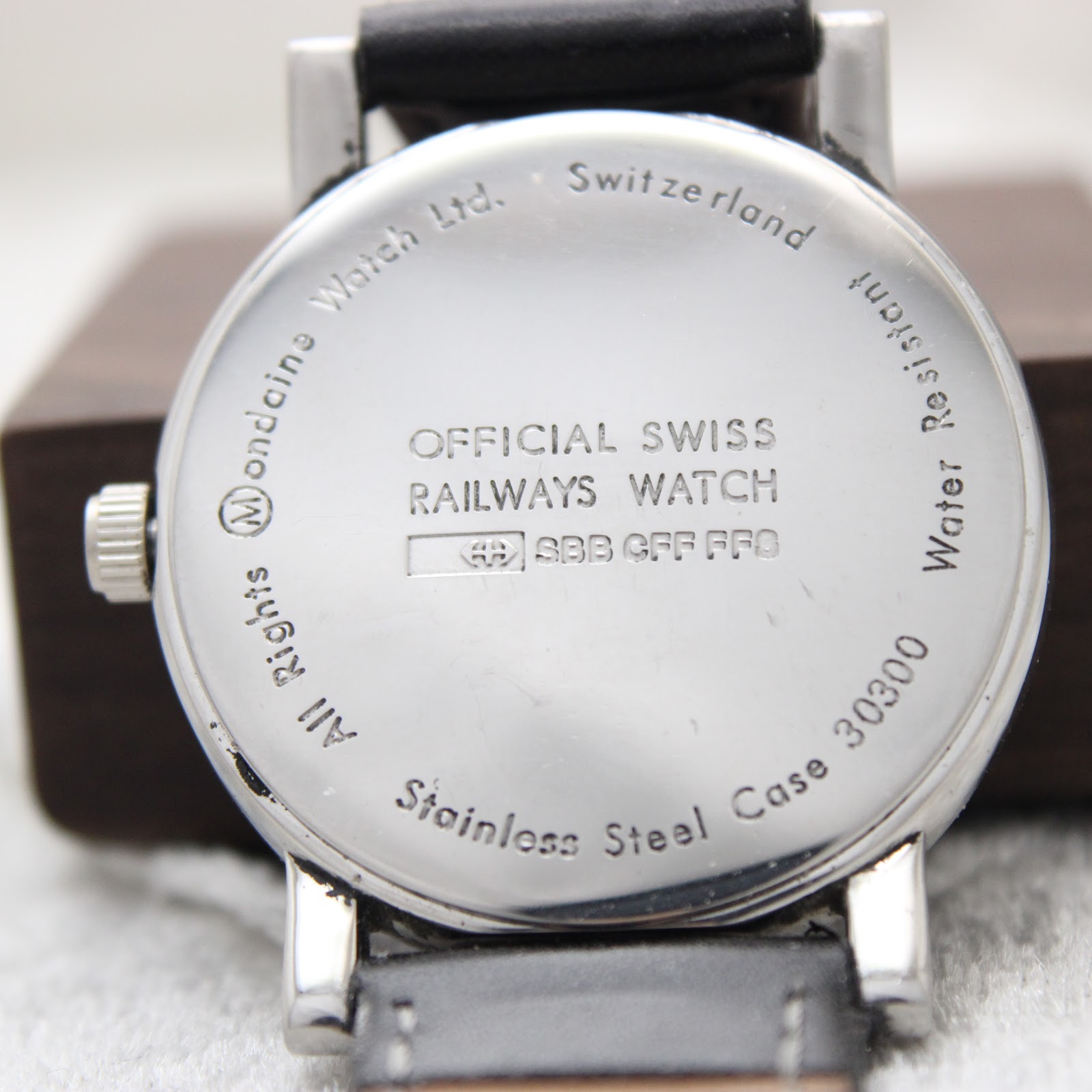 Detailed close-up of the watch's stainless steel case back, featuring "Official Swiss Railways Watch," the "SBB CFF FFS" logo, and the model number "30300."
