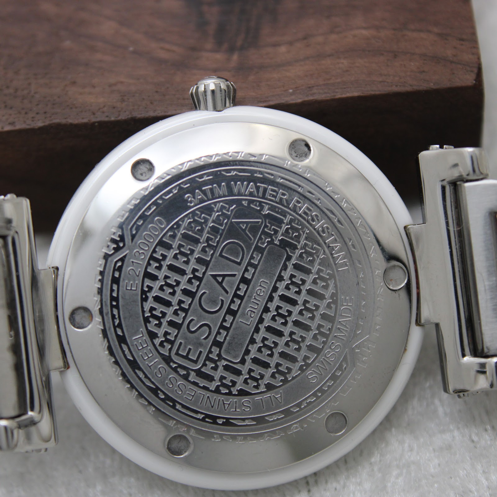 Detailed close-up of the Escada Lauren watch case back, showing engravings for brand, model, reference number, water resistance, and "Swiss Made".