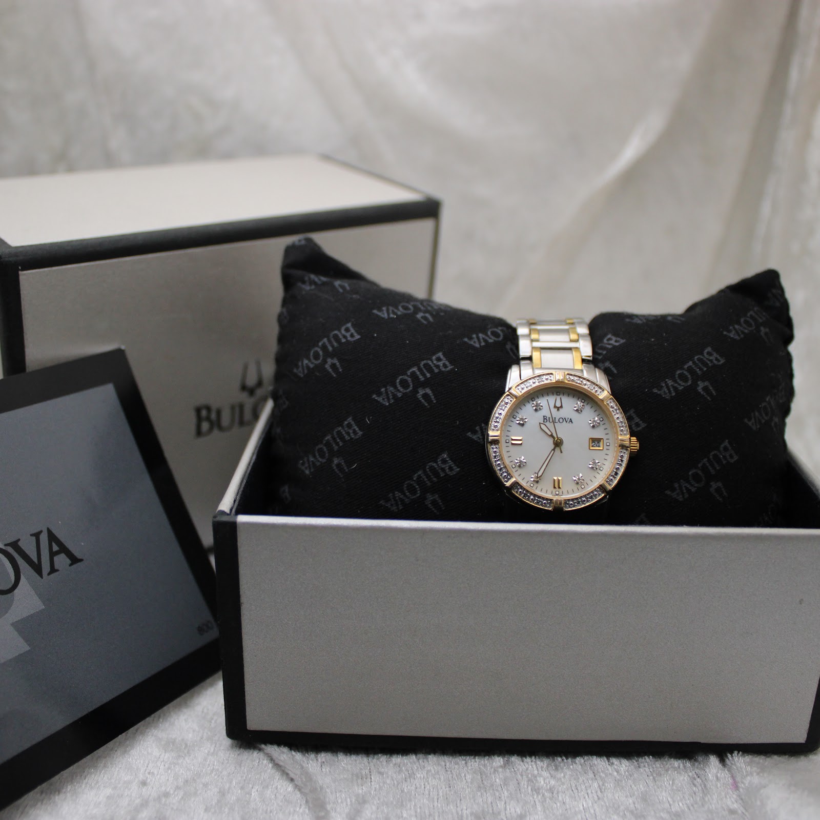 The Bulova watch displayed in its original presentation box with cushion and booklet.