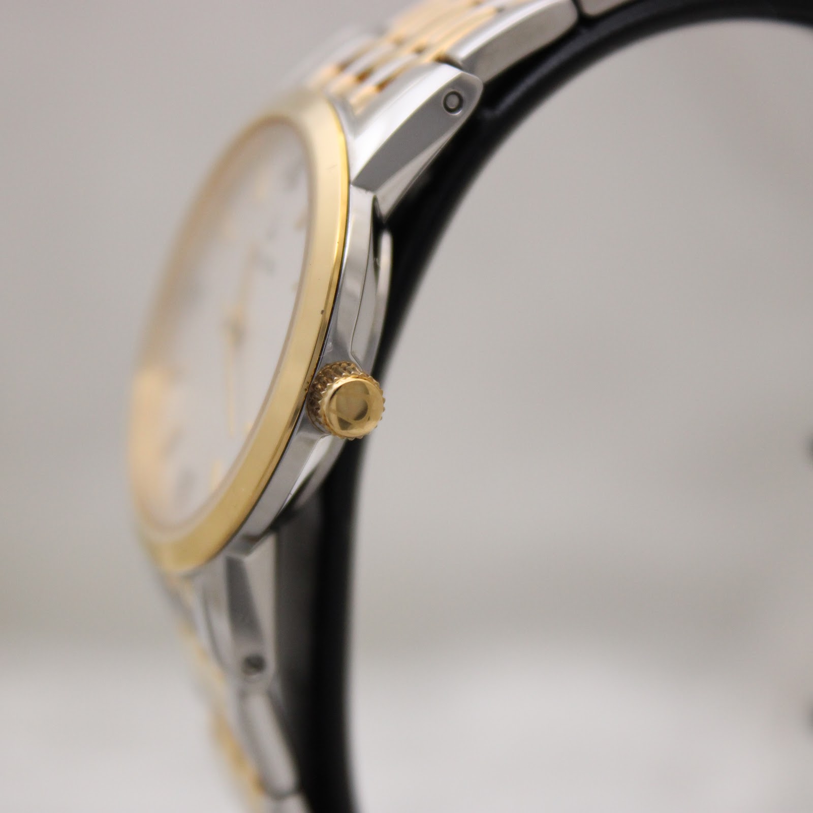 Side profile view of the Bulova watch, showing the gold-tone crown and thin case.