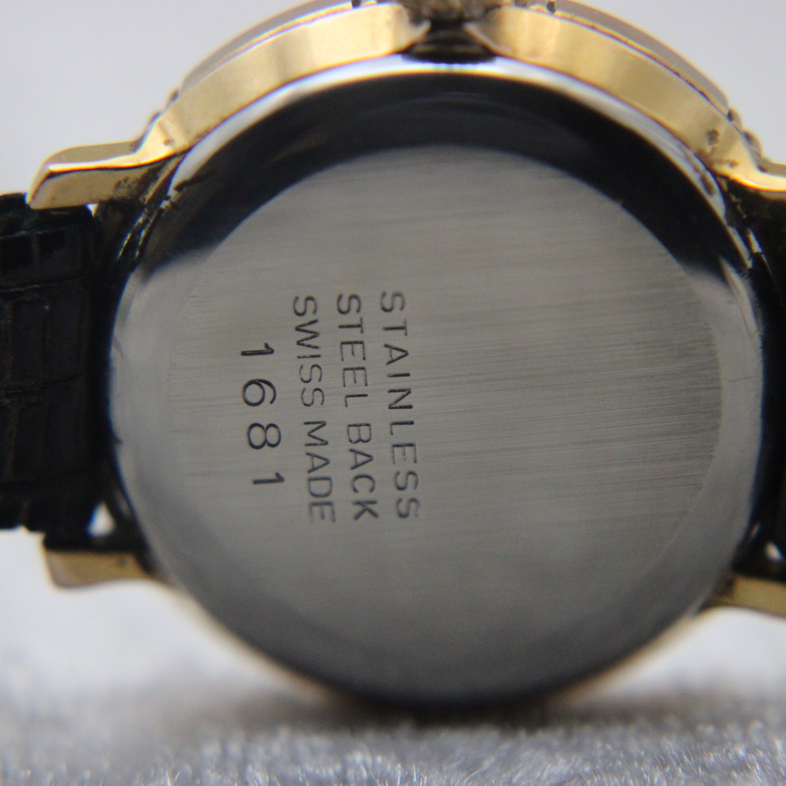 Close-up of the watch case back showing "STAINLESS STEEL BACK SWISS MADE 1681" engraving.