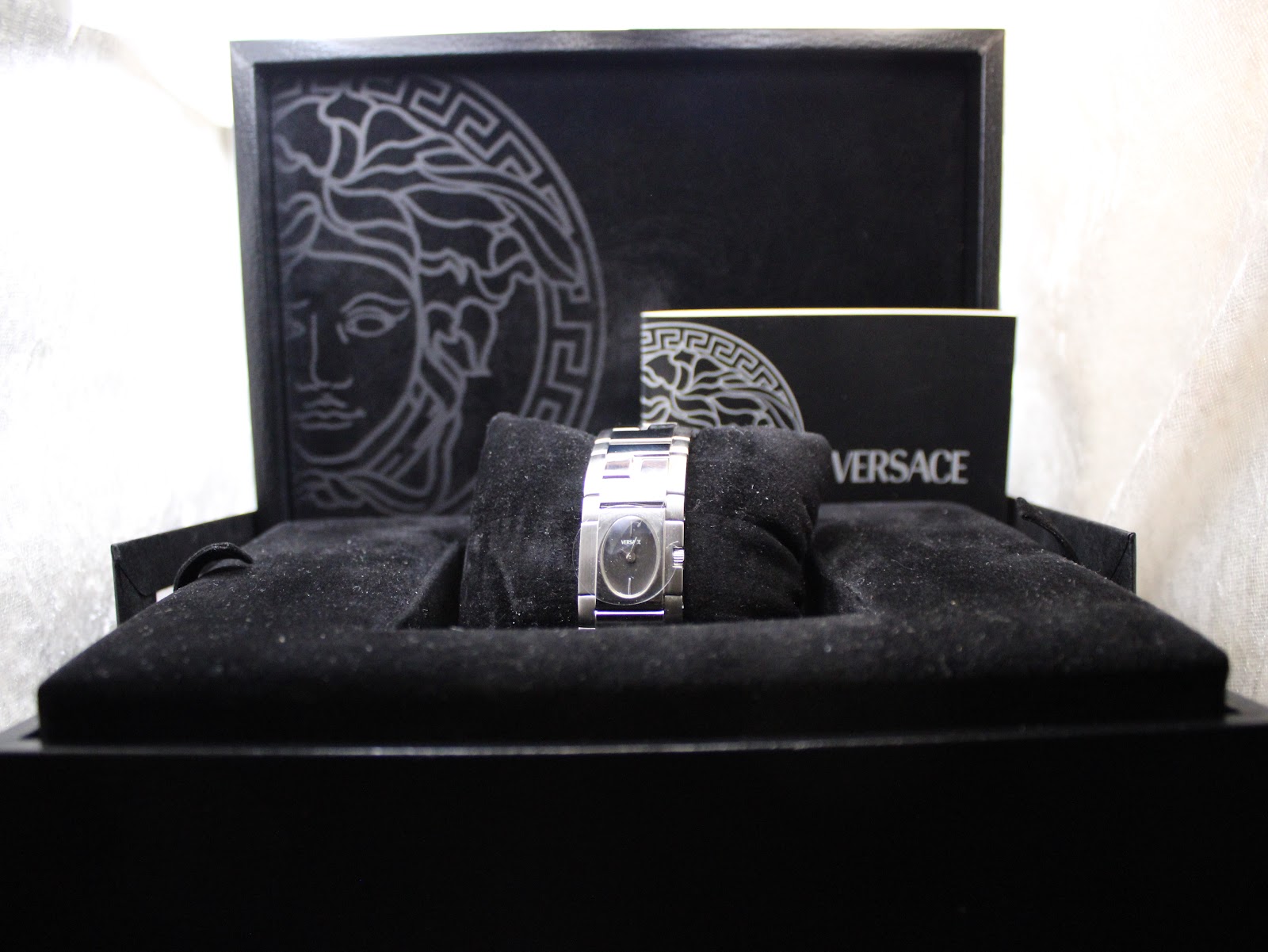 The Versace ESQ99 watch presented beautifully within its original black velvet-lined box with the included booklet.
