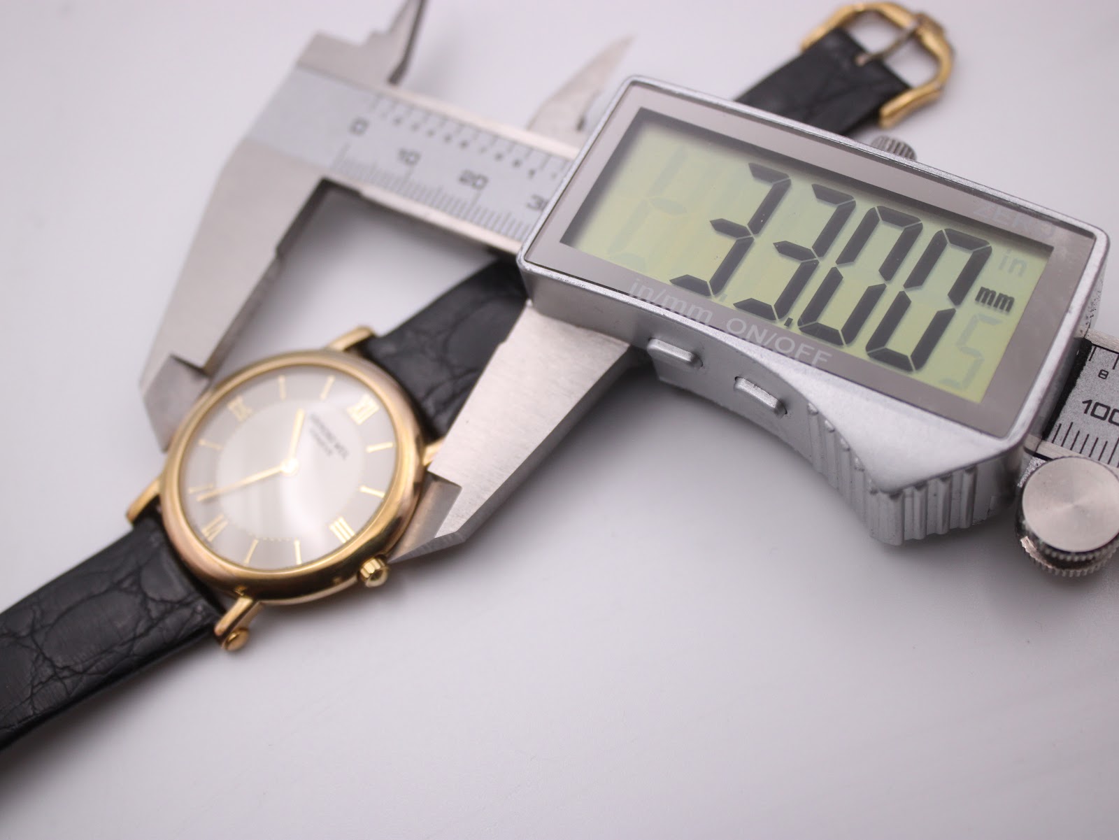 View of the Raymond Weil watch with a digital caliper measuring the case diameter at 33.00mm.