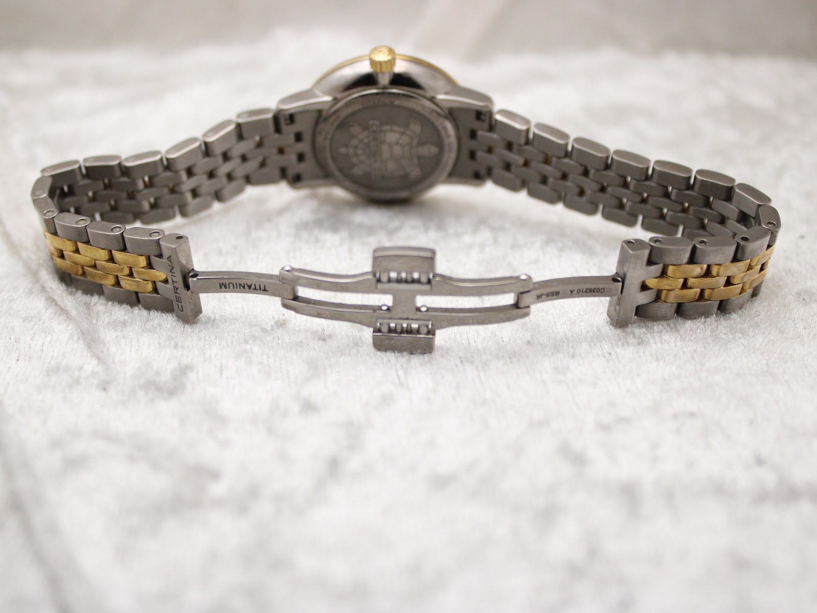 Rear view of the Certina DS Caimano watch, displaying the engraved case back and the open, signed titanium clasp.