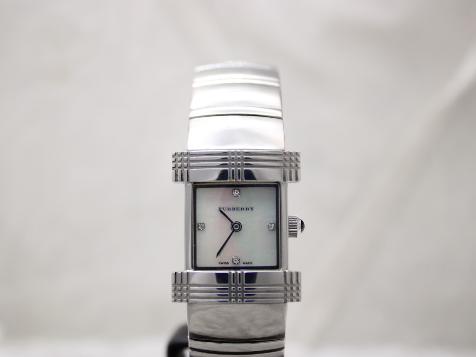Slightly angled front view of the Burberry BU4500 watch, highlighting the reflective silver case and bracelet details.