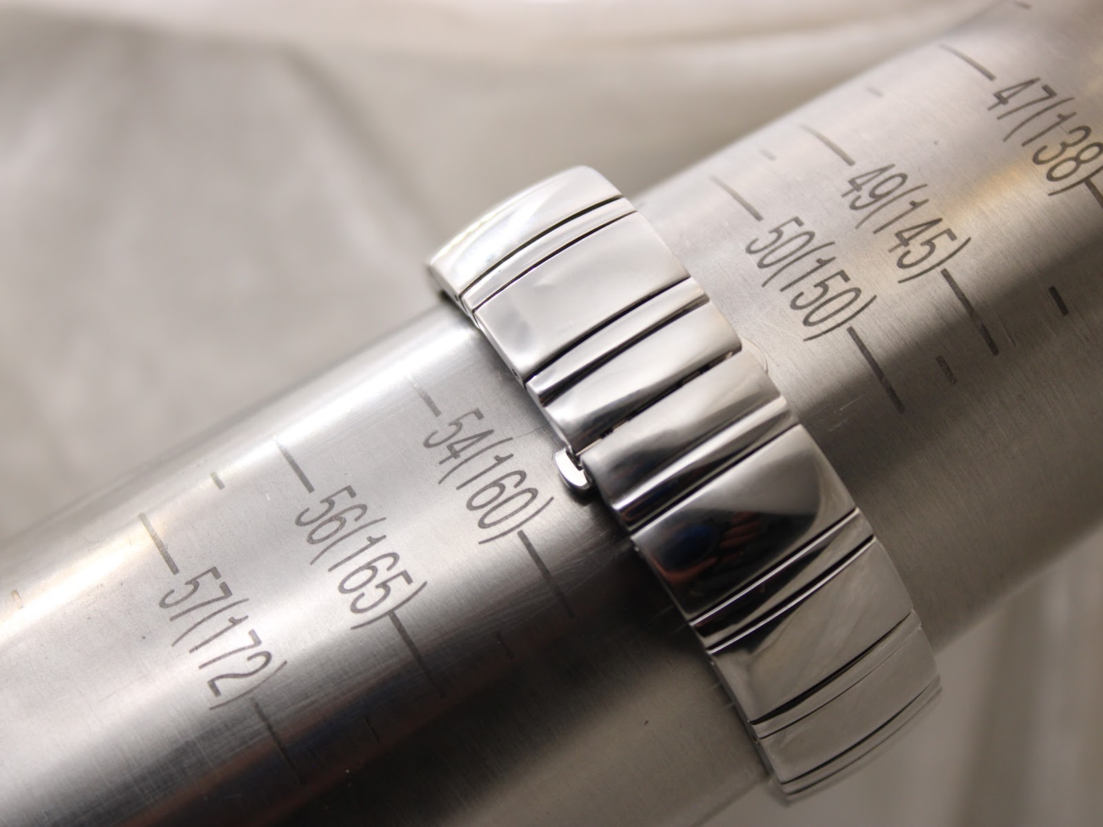 The watch bracelet wrapped around a wrist sizing gauge, indicating a current wrist circumference of approximately 160mm.