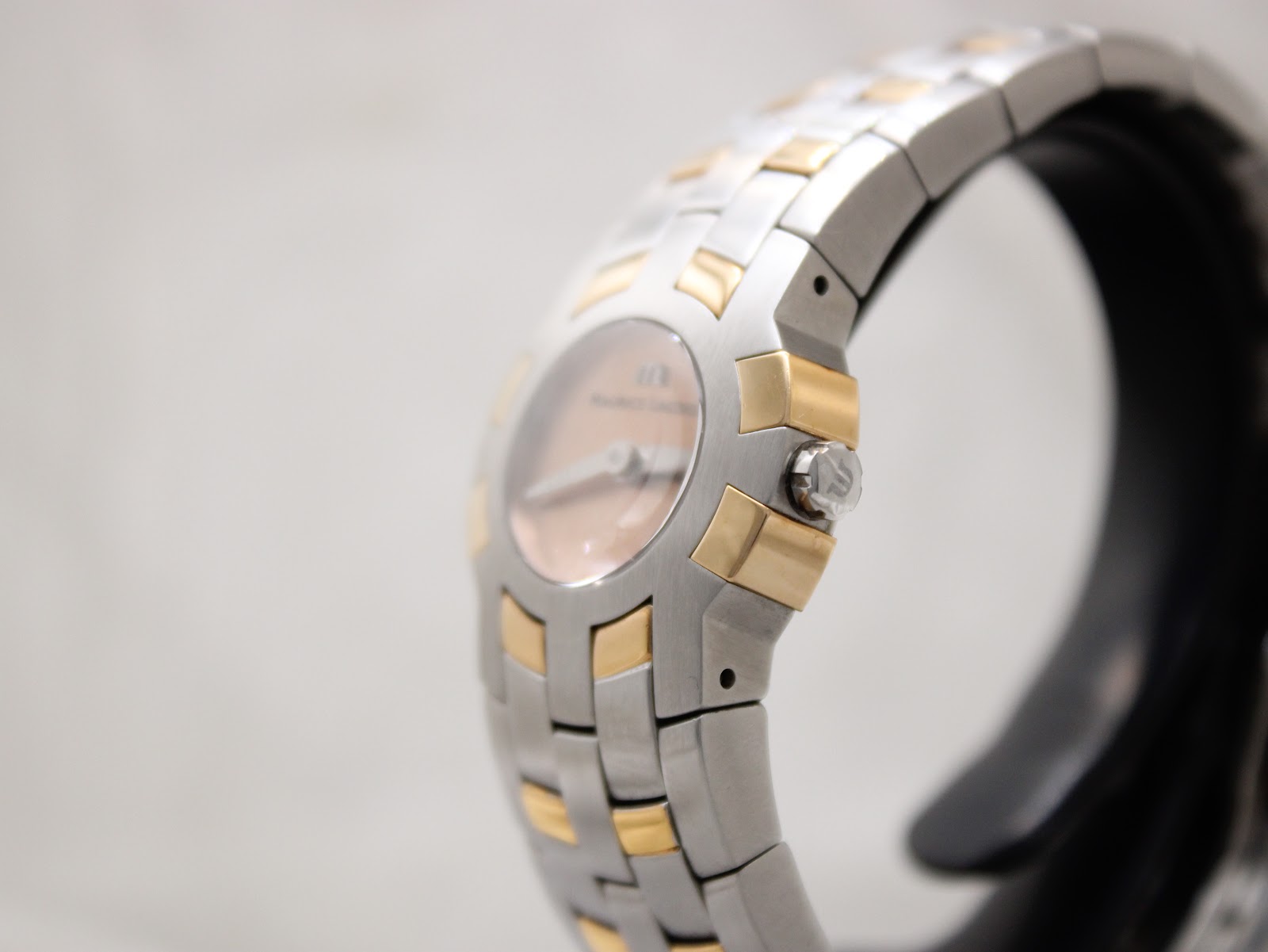Side profile view of the Maurice Lacroix watch showing the crown and the curved case design.