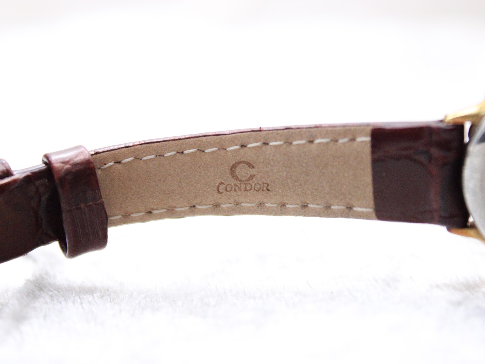 Close-up of the underside of the brown leather strap, showing the 'CONDOR' brand stamp and stitching.
