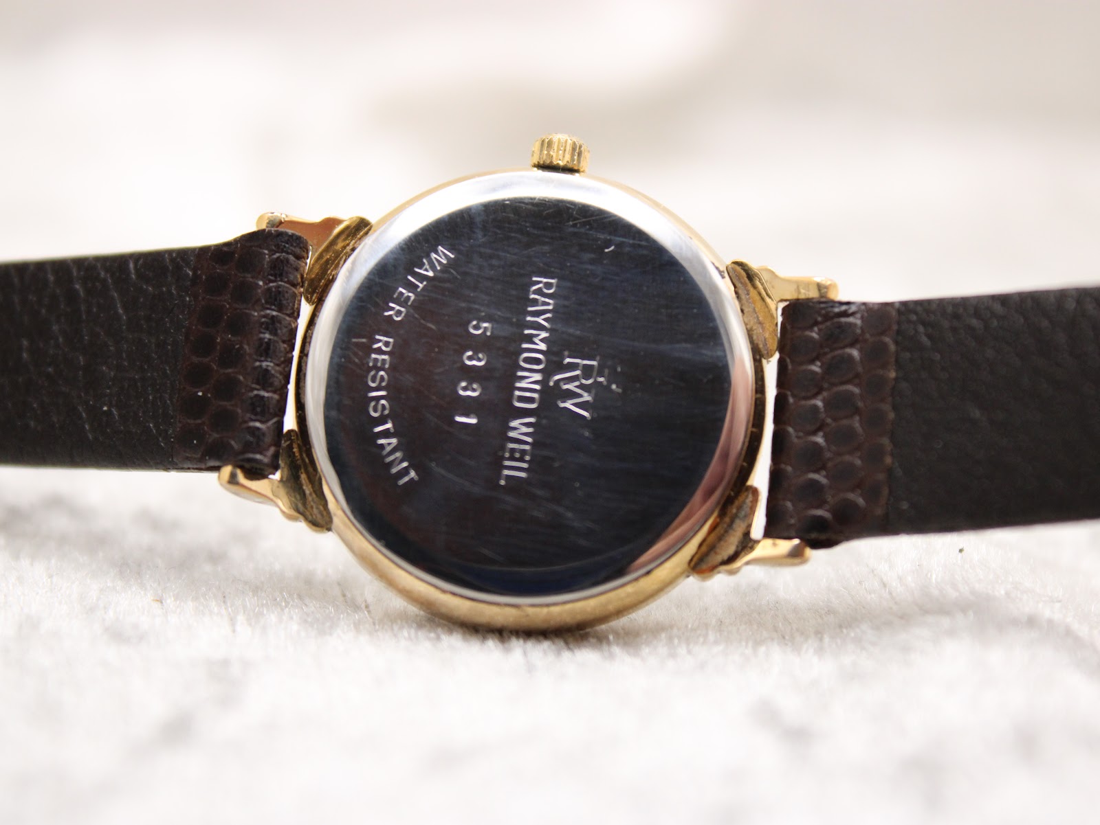 Close-up of the stainless steel case back of the Raymond Weil 5331, engraved with model number and 'water resistant'.