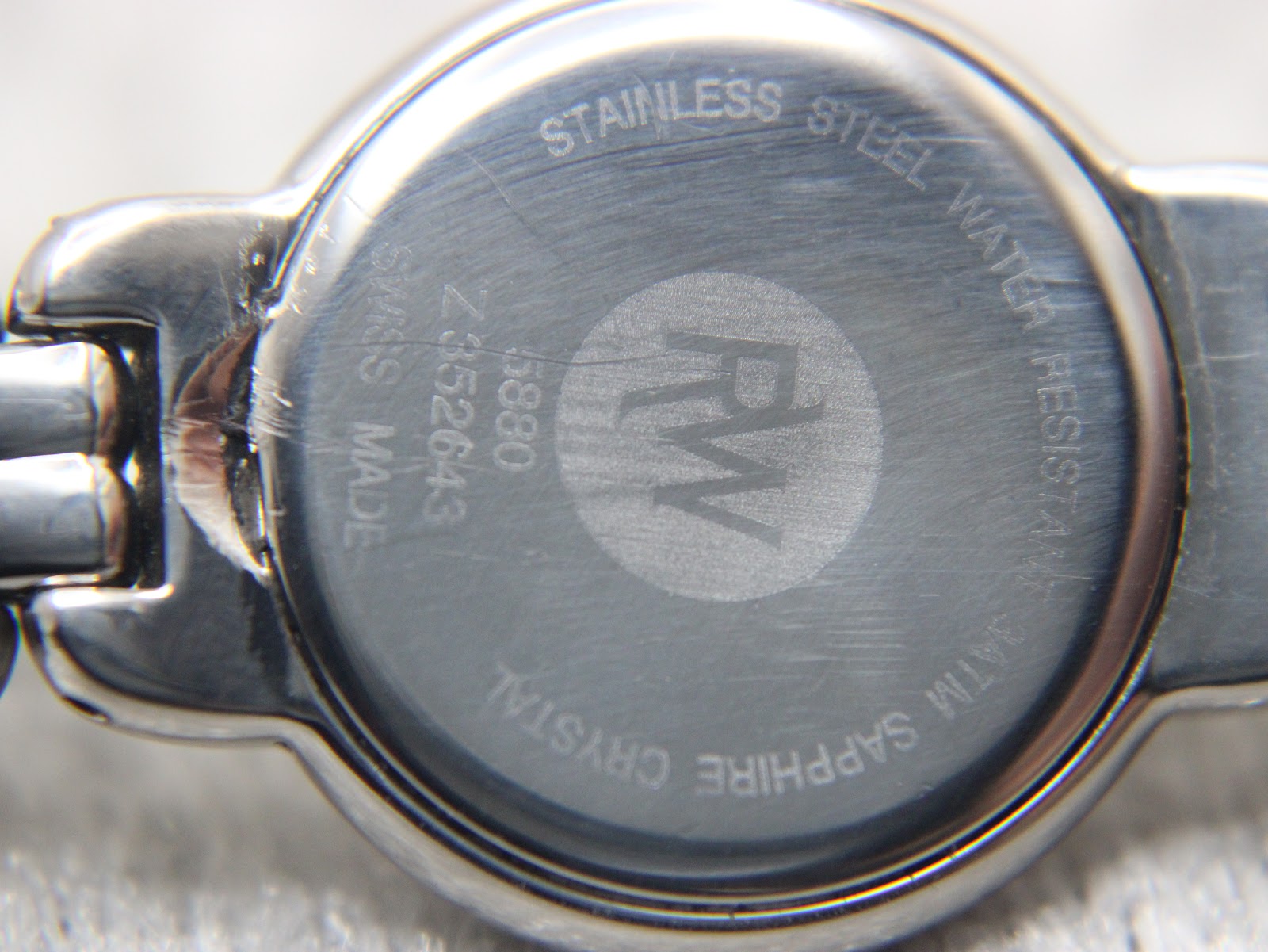 Close-up of the stainless steel case back, showing 'Raymond Weil Genève', '5880', 'Z352643', 'Swiss Made', 'Stainless Steel', 'Water Resistant 3ATM', and 'Sapphire Crystal' engravings.