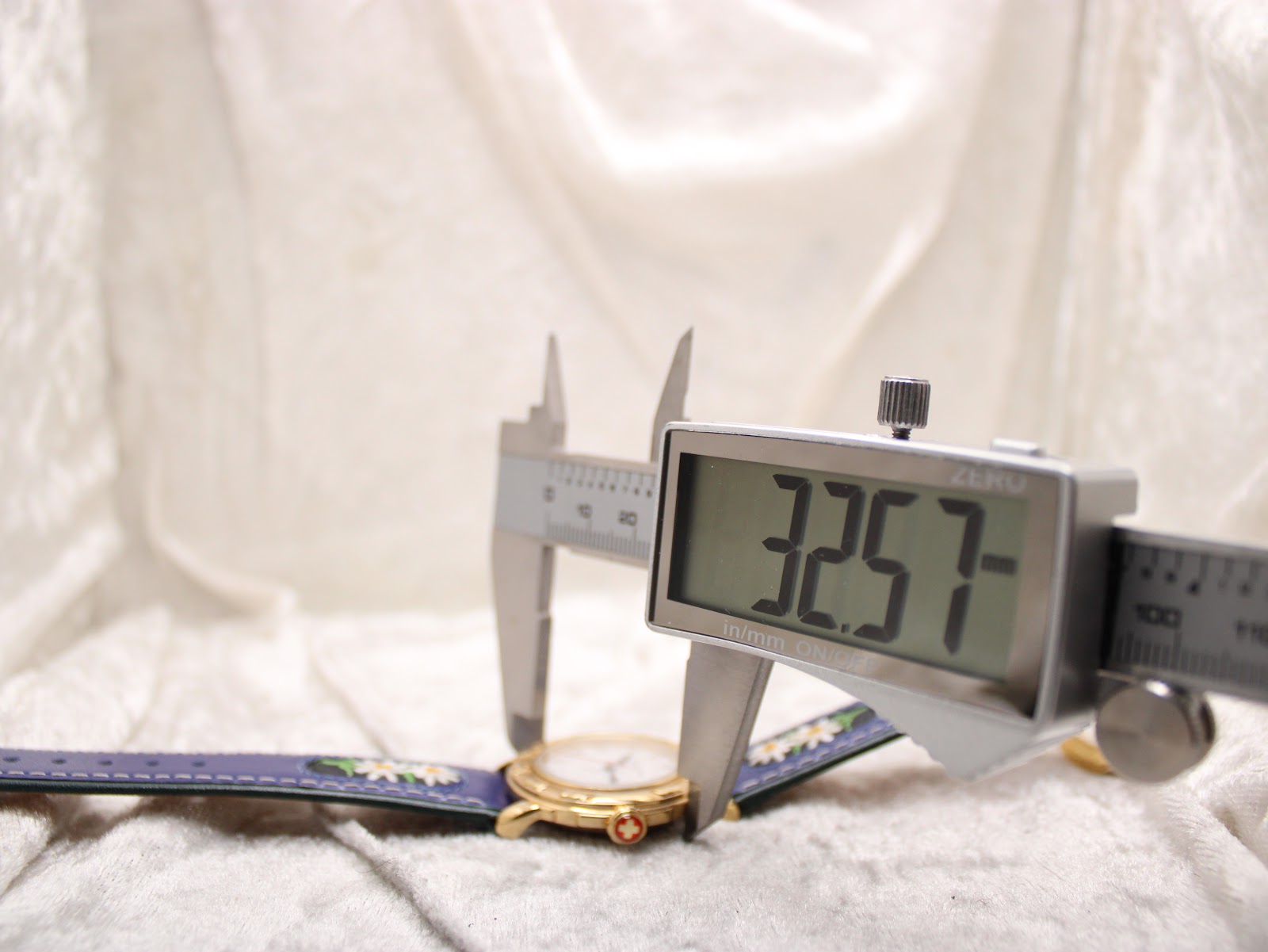 Digital caliper measuring the Michel Jordi Genève watch case diameter at 32.57mm.