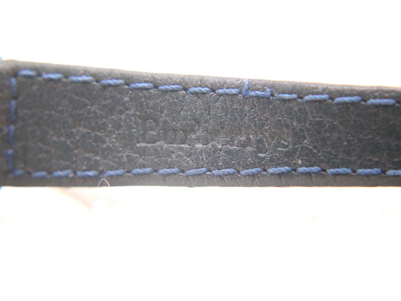 Close-up of the blue leather strap, showing the texture and "Burberrys" debossed mark.