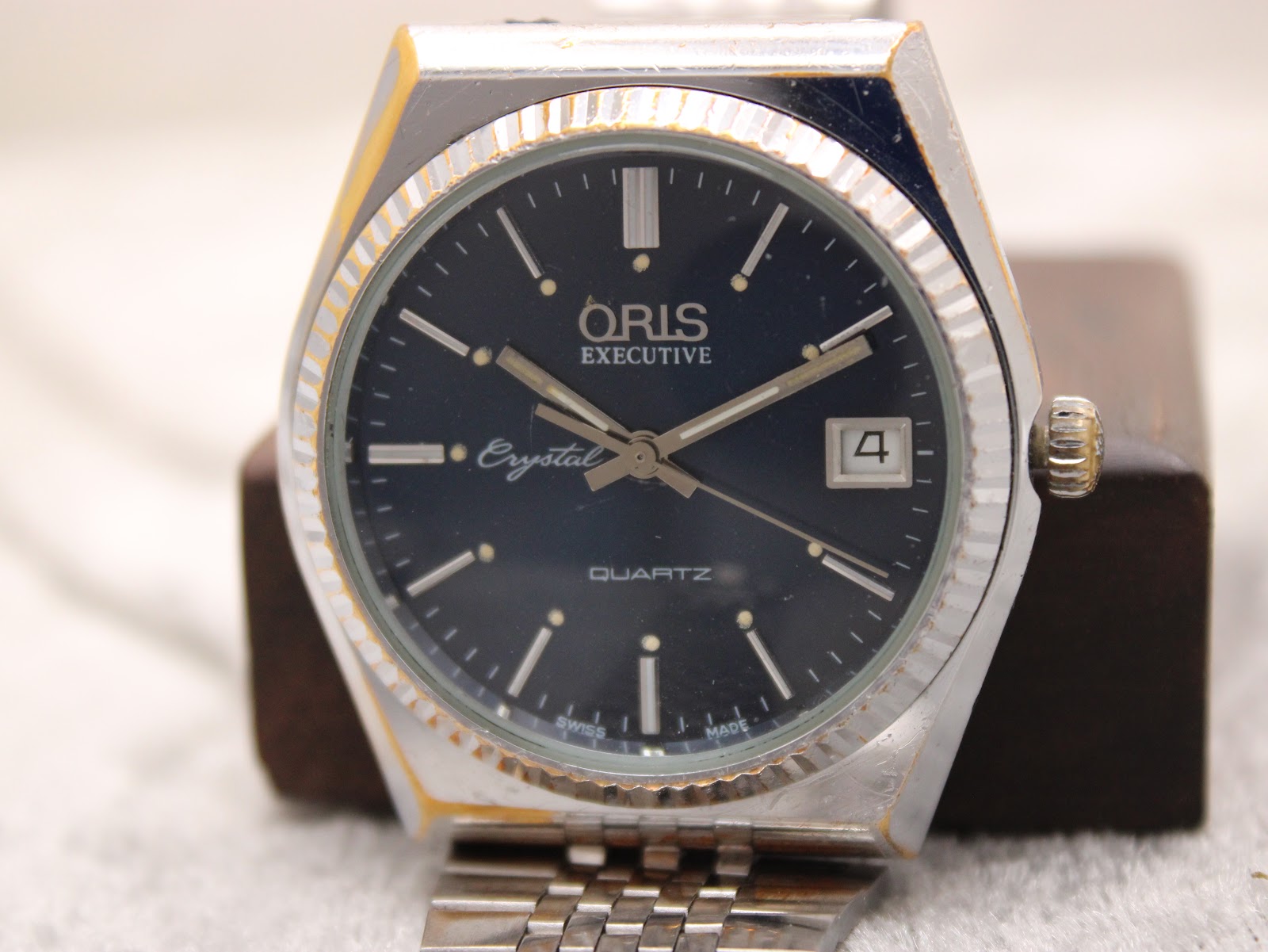 Close-up, slightly angled view of the Oris Executive Crystal's navy dial, indices, and date window.