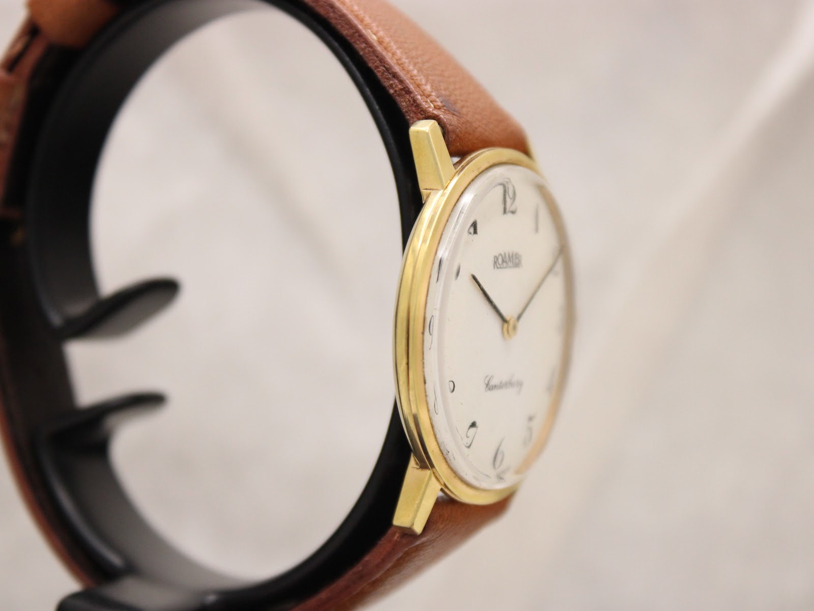 Angled side view of the Roamer Canterbury watch, highlighting the slender gold-tone case profile and simple lugs.