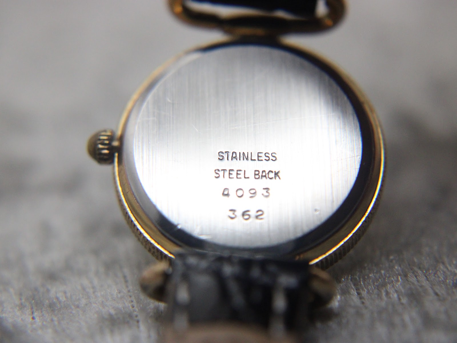 Close-up of the watch's stainless steel case back, clearly showing the engraved text 'stainless steel back', '4093', and '362'.