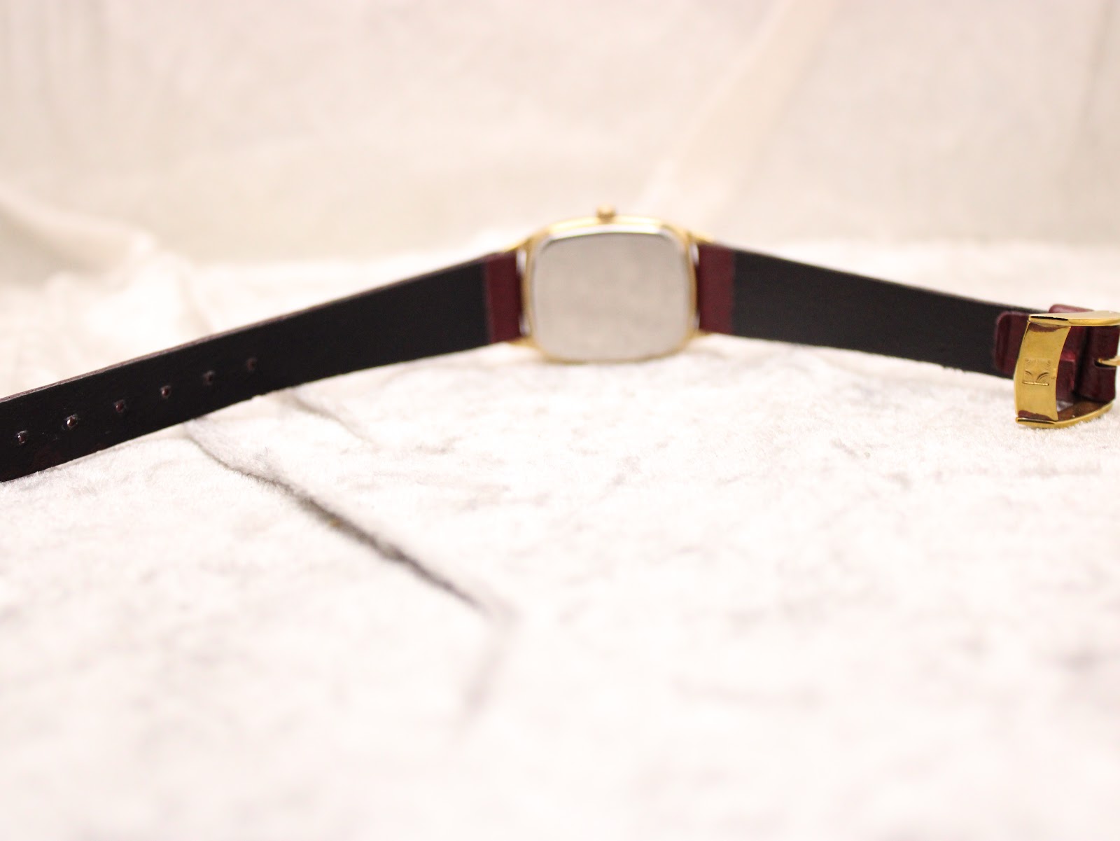 Back view of the Zenith watch with strap laid flat, showing case back and buckle.