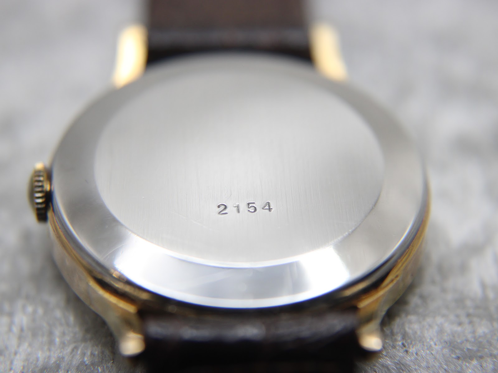 Exterior of the watch case back, displaying the model reference number "2154".