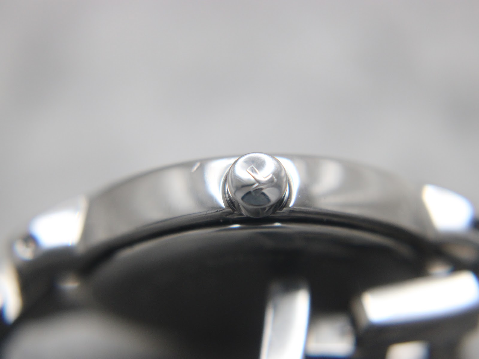 Macro shot of the Tissot signed crown with the 'T' logo.