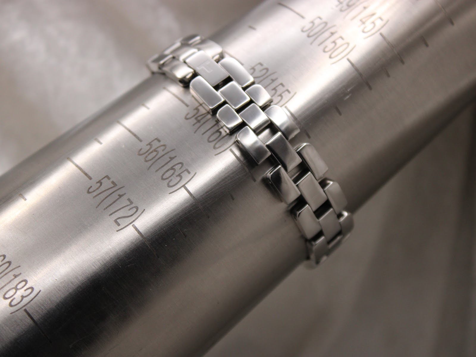 Stainless steel bracelet being measured on a wrist sizing gauge, showing a circumference of 160mm.