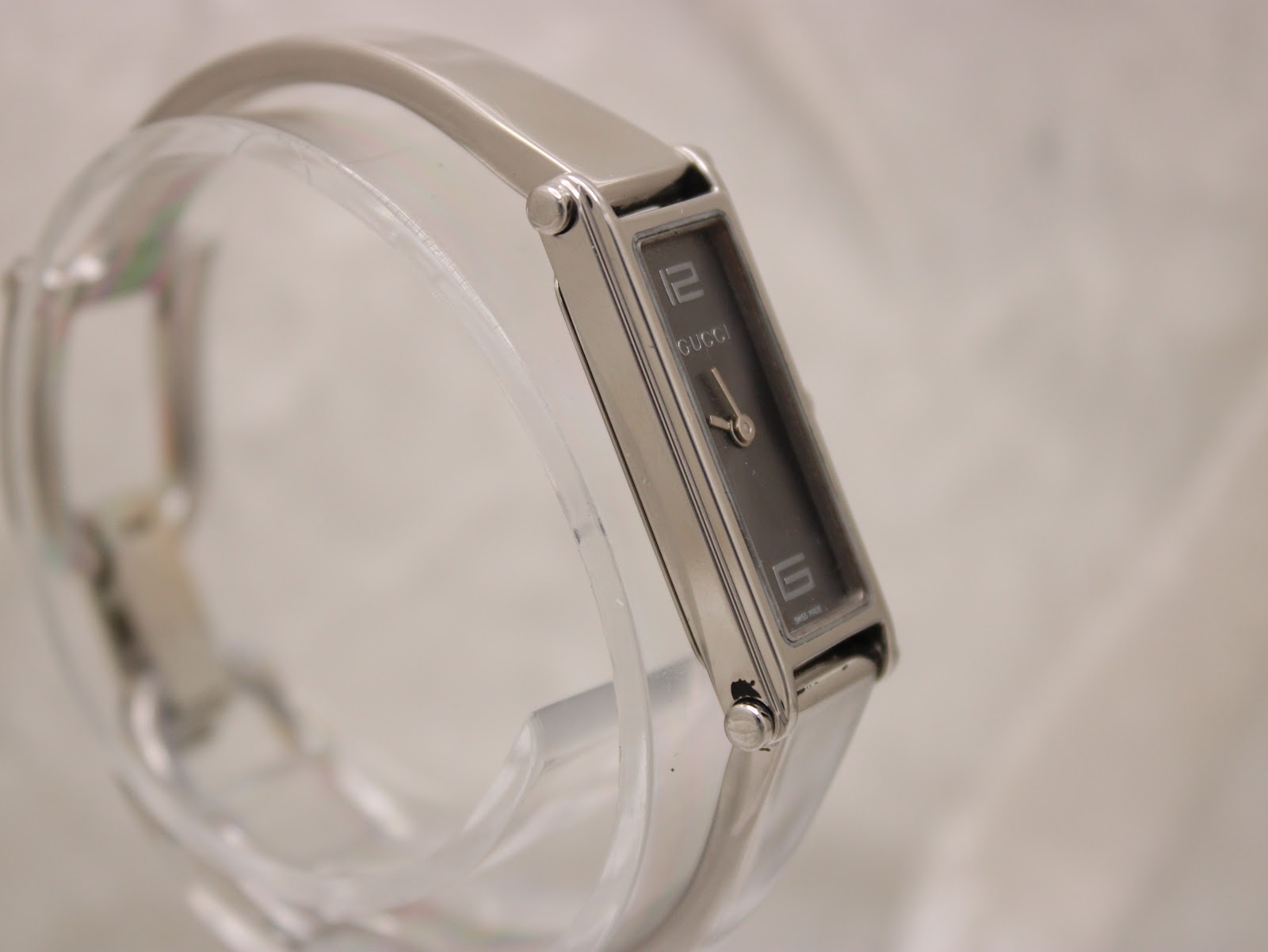 Angled view of Gucci 1500L watch showing dial, case, and bracelet design.
