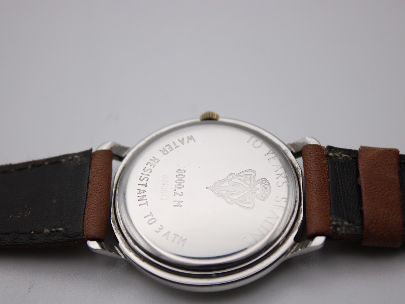 Another close-up of the watch case back, showing the Gucci logo and 'water resistant to 3 ATM' text clearly.