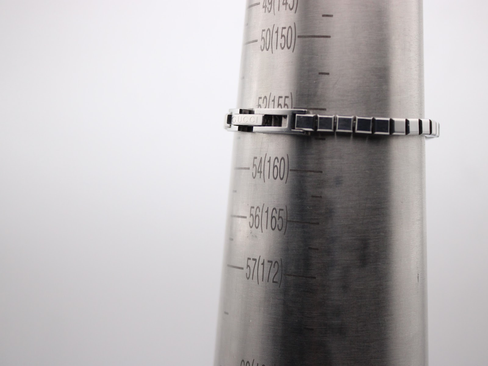 The Gucci G-Frame watch bracelet wrapped around a wrist sizing gauge, indicating a wrist fit of approximately 155mm (15.5cm).