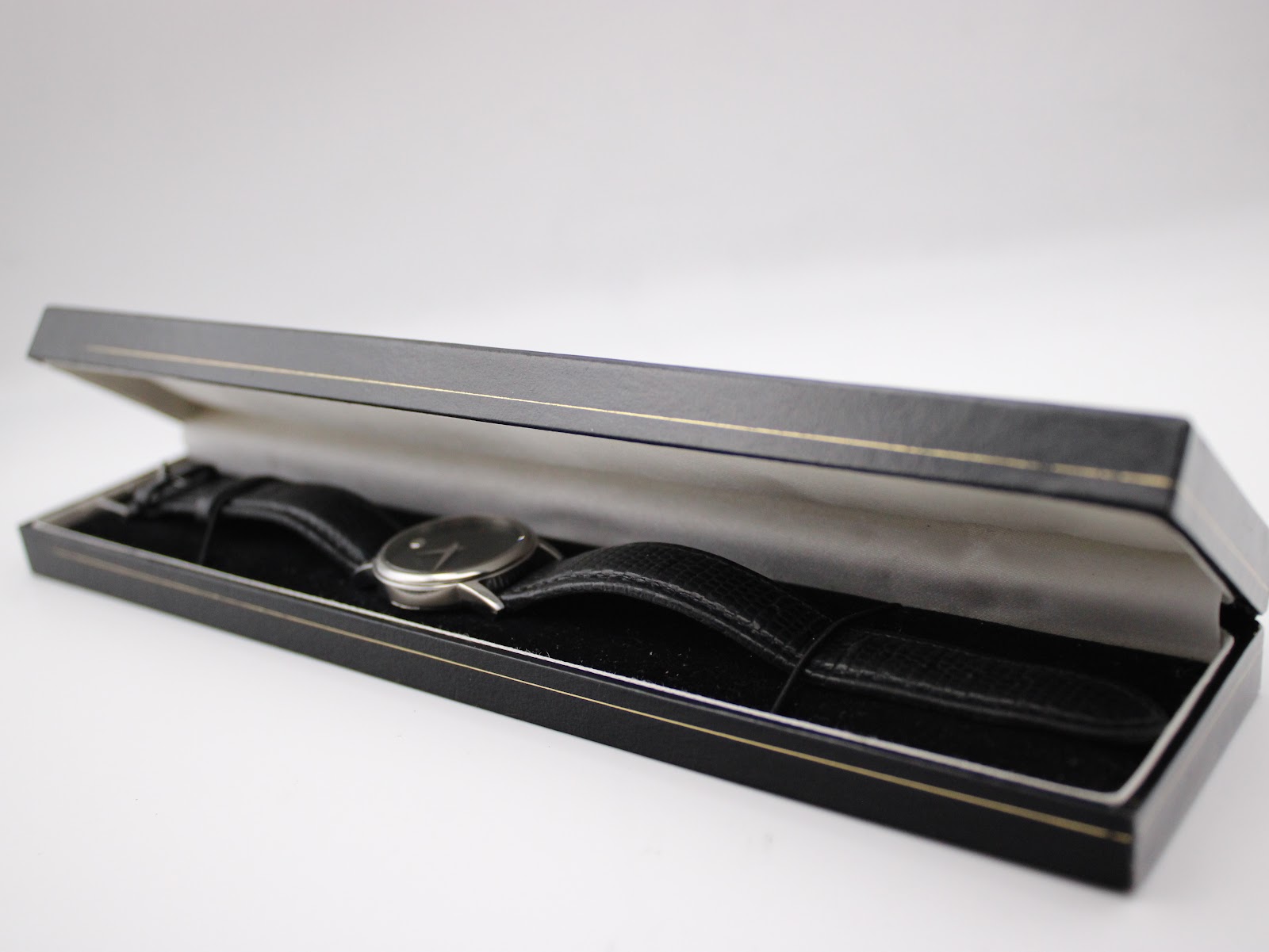 The Movado Museum watch presented neatly inside a sleek black and gold rectangular presentation box.