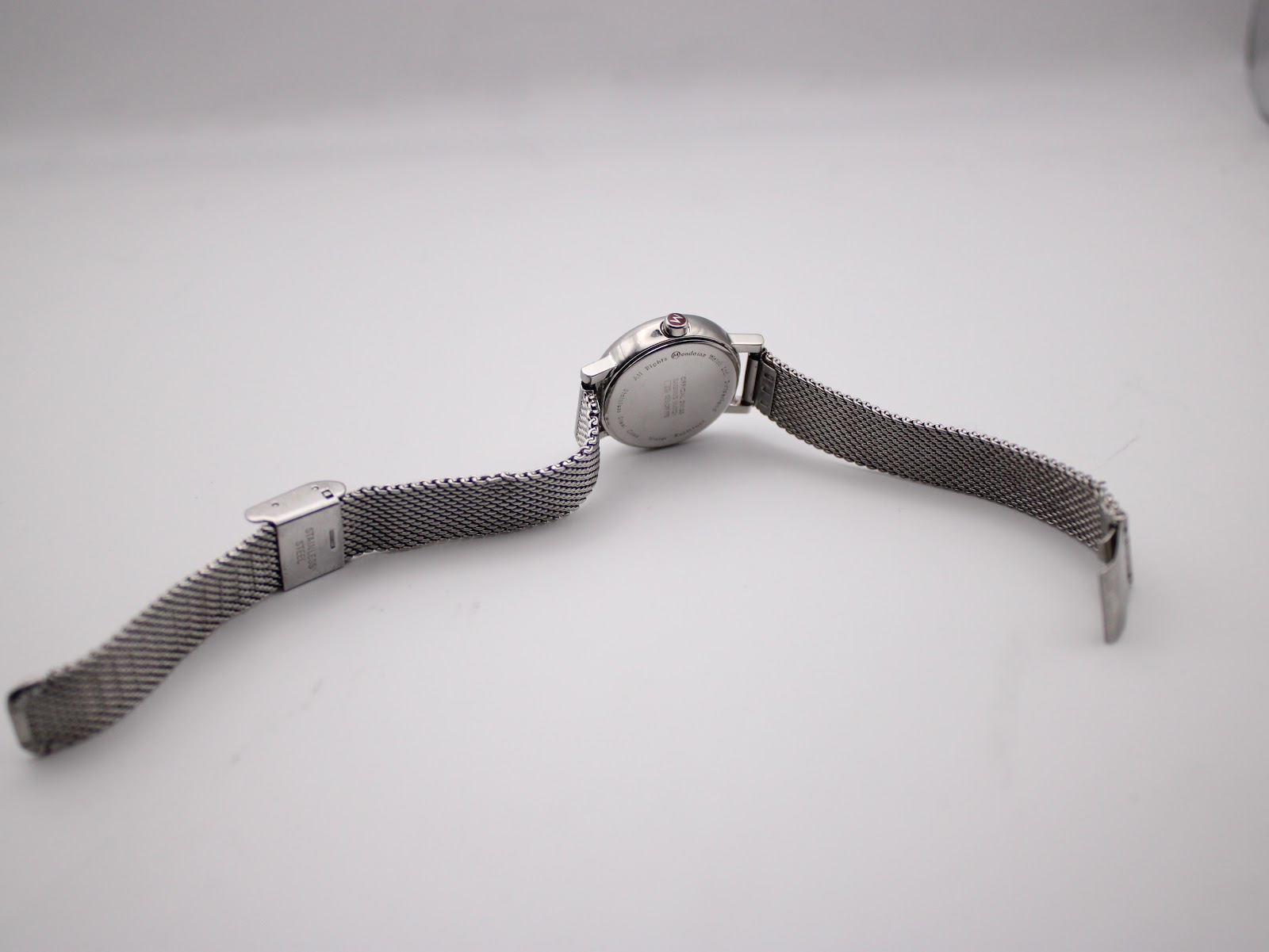 Back view of the watch and mesh bracelet showing the clasp mechanism.