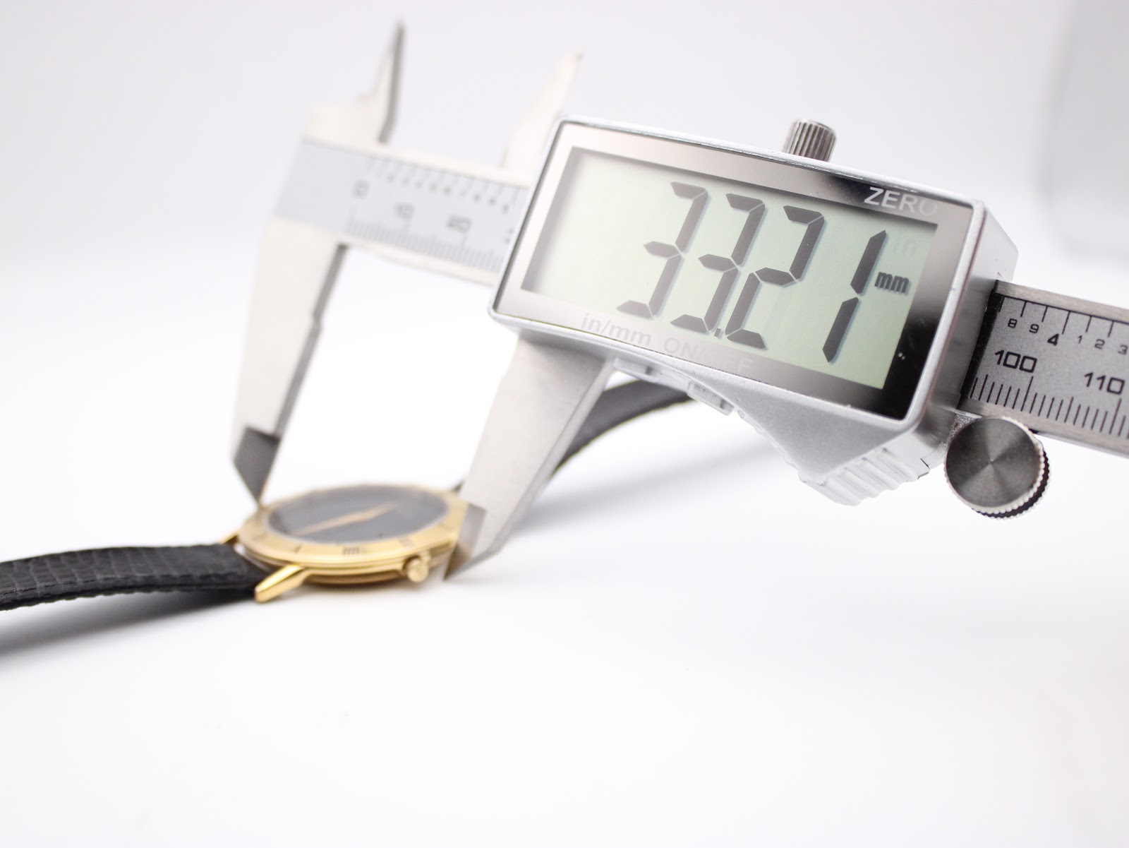 Digital caliper measuring the case diameter of the watch at 33.21mm, confirming its exact size.