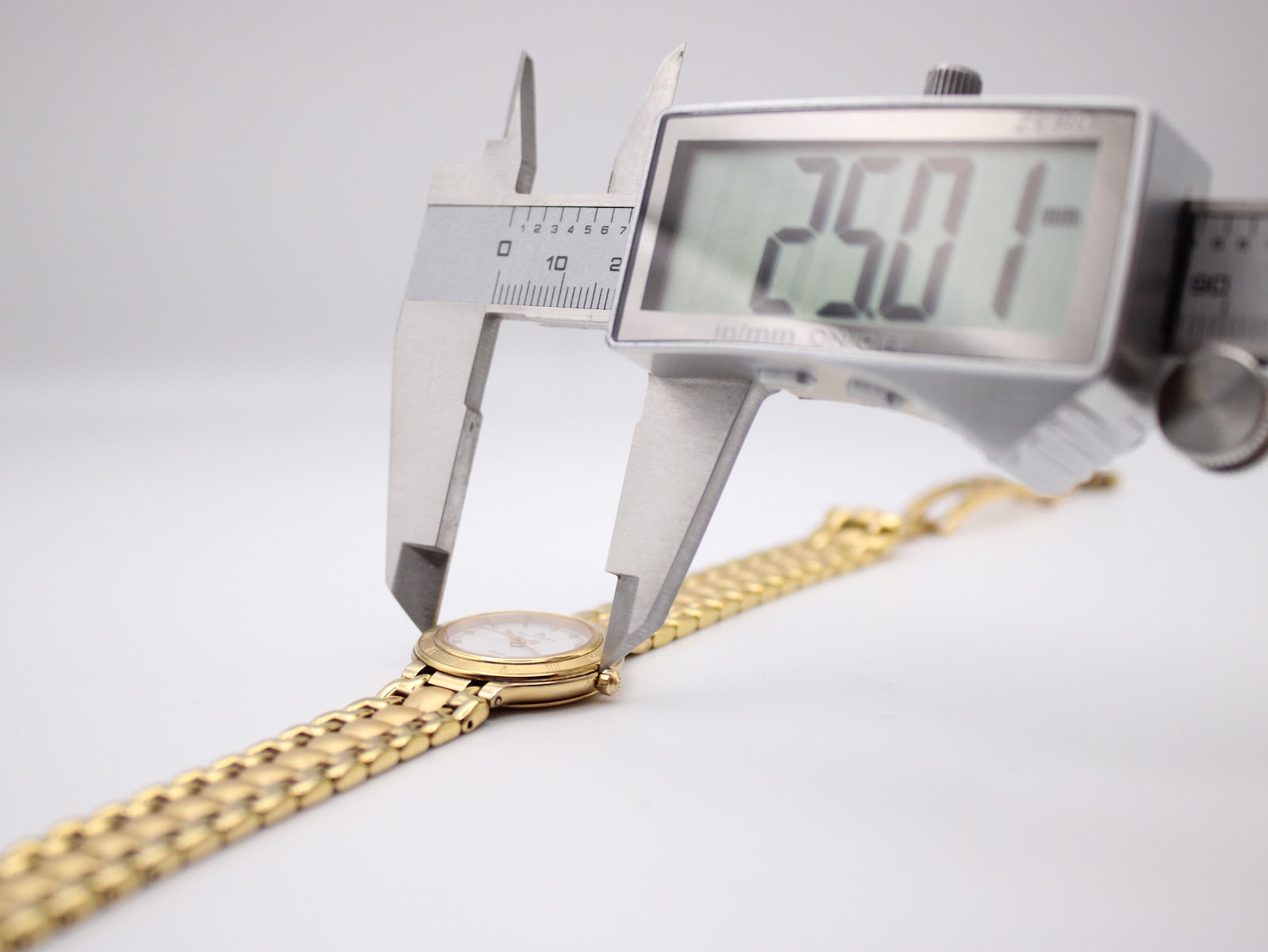Digital caliper measuring the case diameter of the Maurice Lacroix watch, displaying 25.01mm.