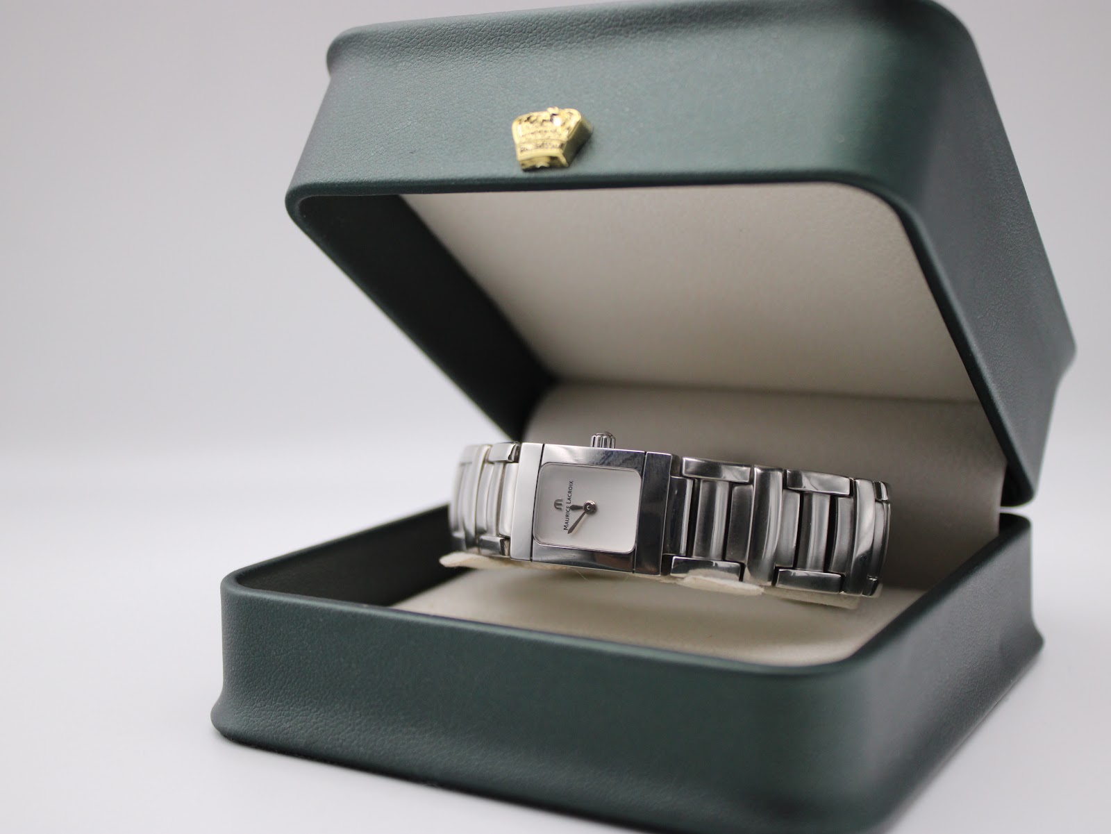 The Maurice Lacroix watch presented in a dark green display box
