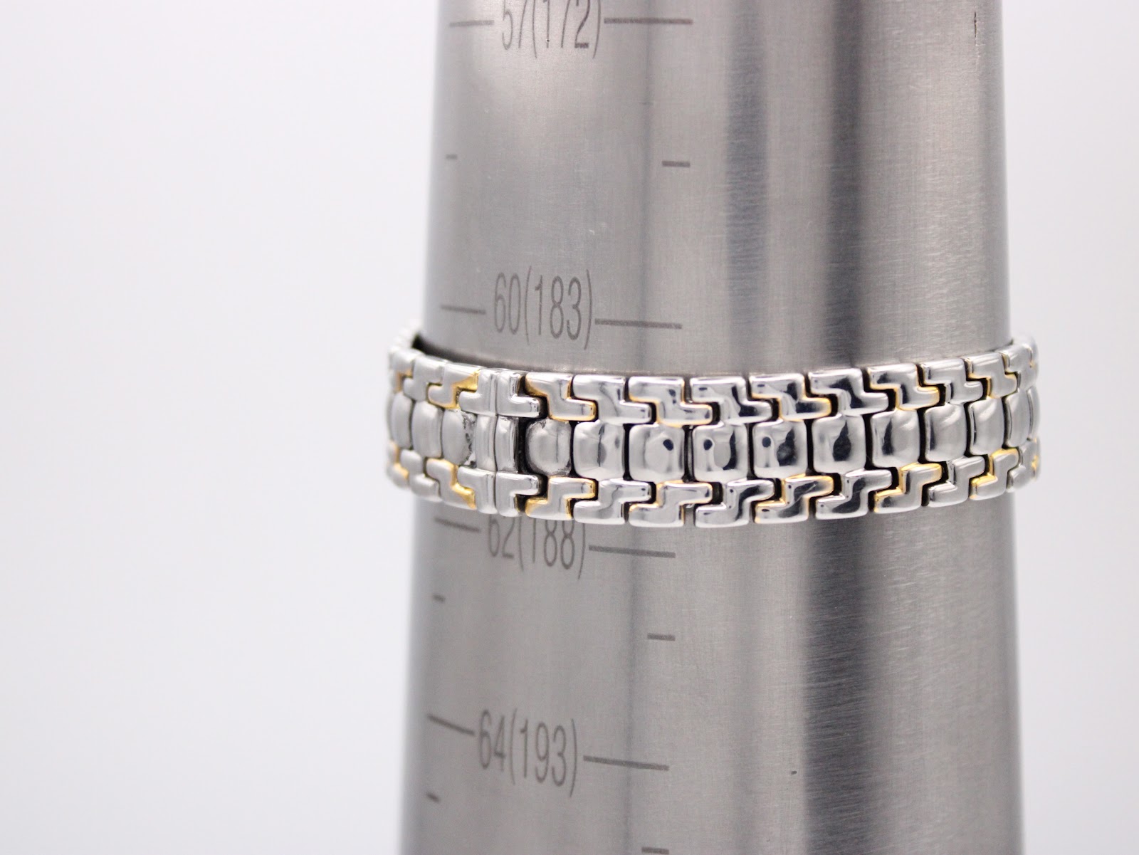 Watch bracelet on a wrist sizing cone, showing a circumference measurement of approximately 183mm or 18.3cm.