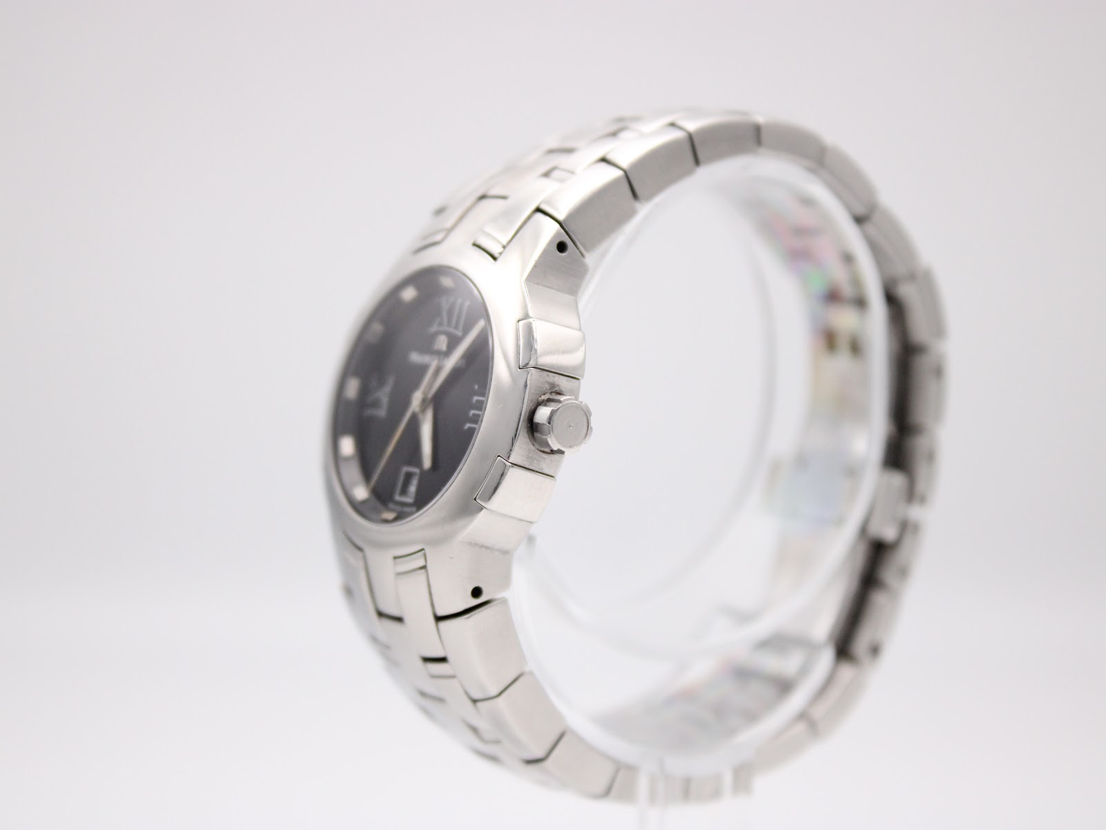Right side view of the Maurice Lacroix watch on a display stand, showing the stainless steel crown.