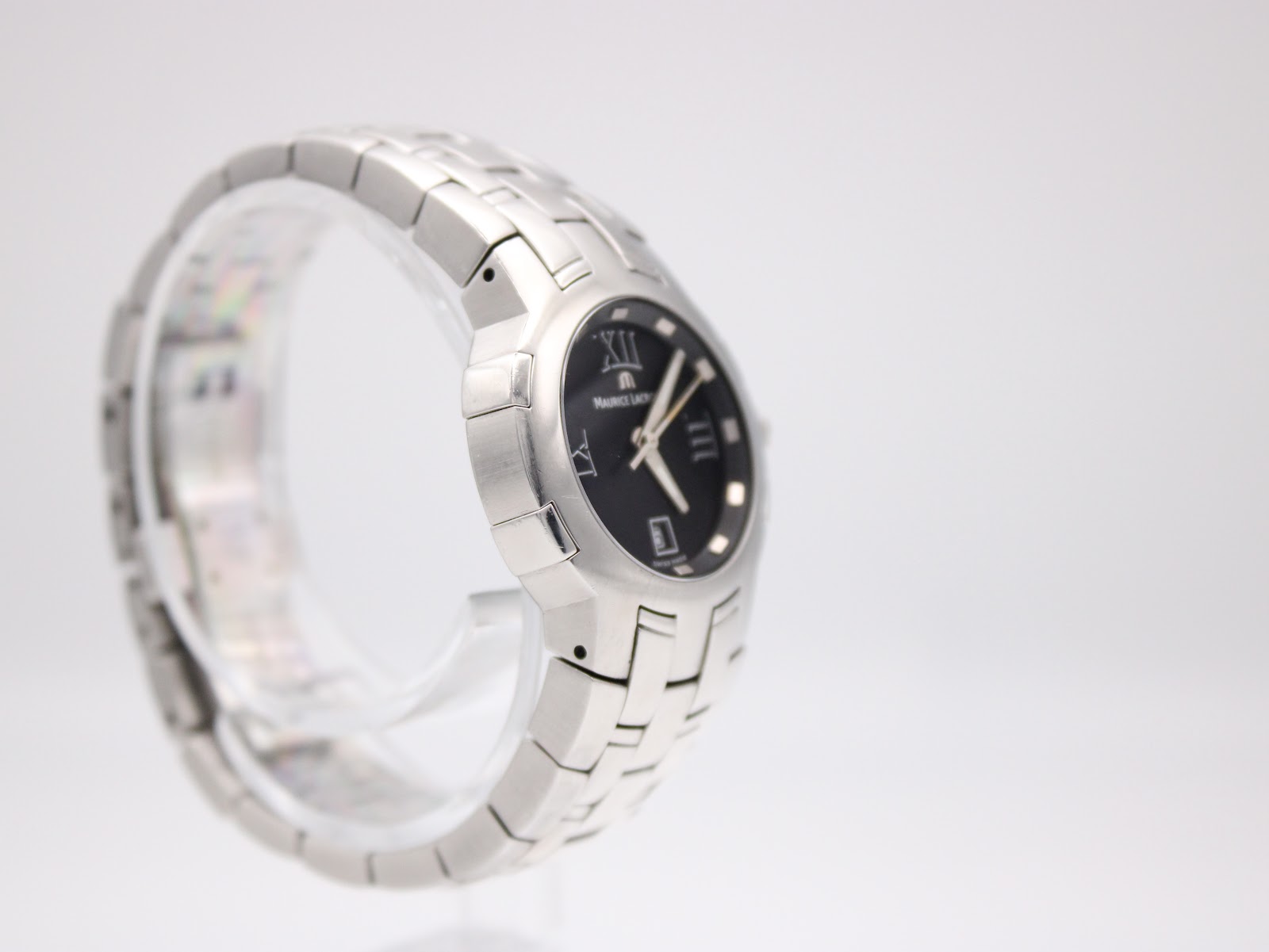 Left side view of the Maurice Lacroix watch on a display stand, highlighting the integrated bracelet design.