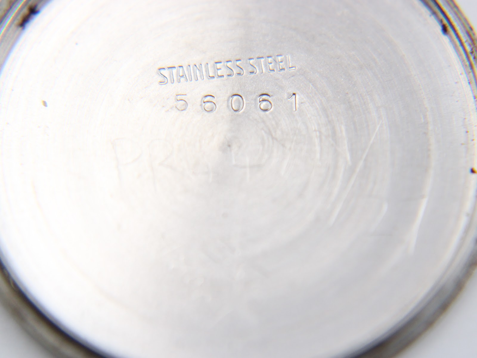 Interior view of the Garrard case back, engraved with 'STAINLESS STEEL' and the model reference '56061'.