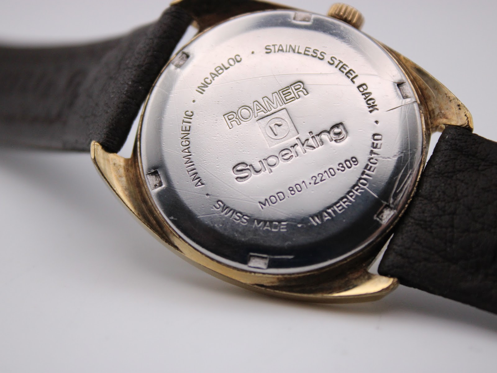 Close-up of the stainless steel screw-back case, showing 'Roamer Superking', model number, 'Swiss Made', 'Waterprotected', and 'Antimagnetic' engravings.
