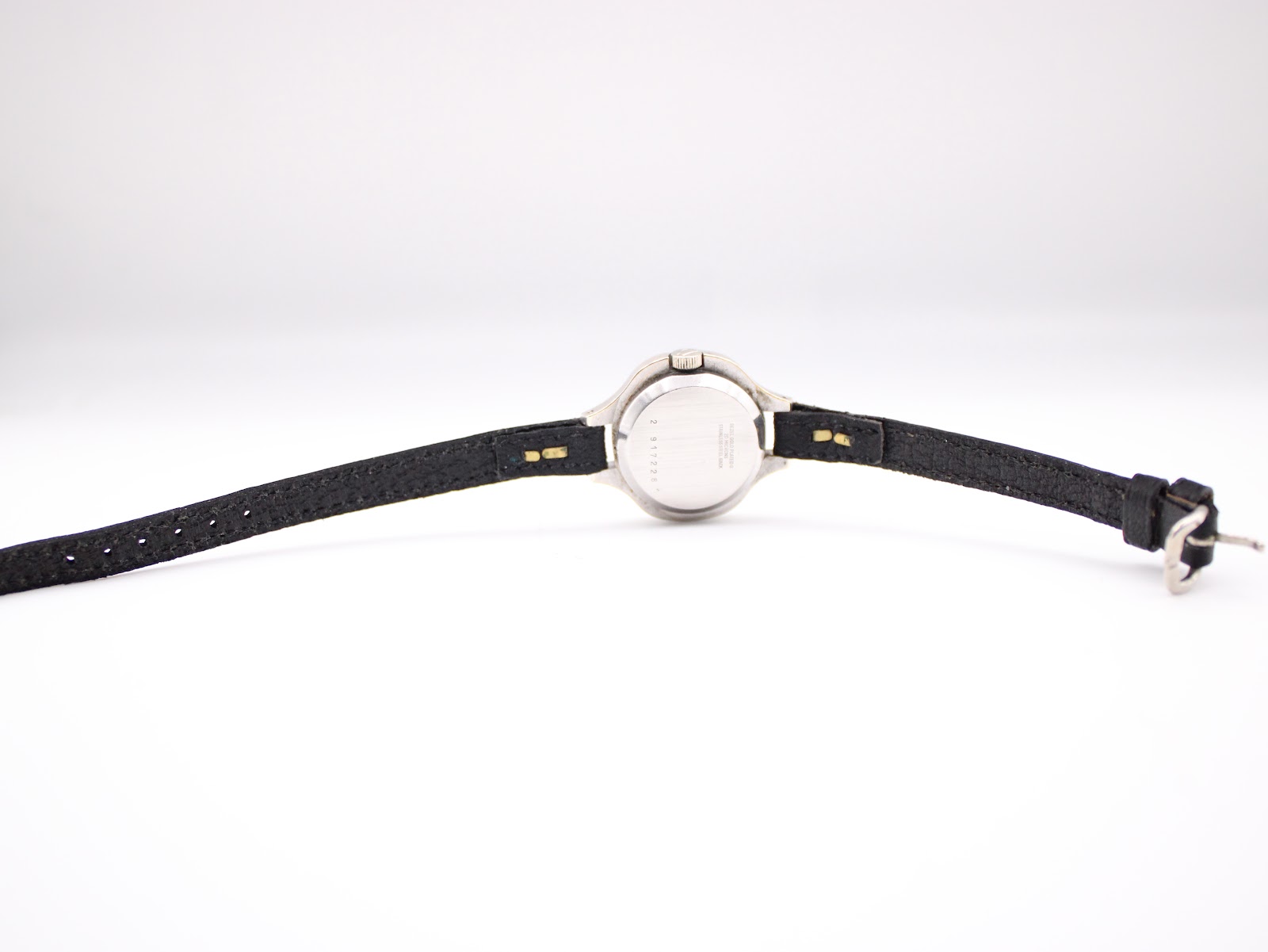 Full rear view of the Bulova Accutron watch with black leather strap laid flat, showing case back and strap details.