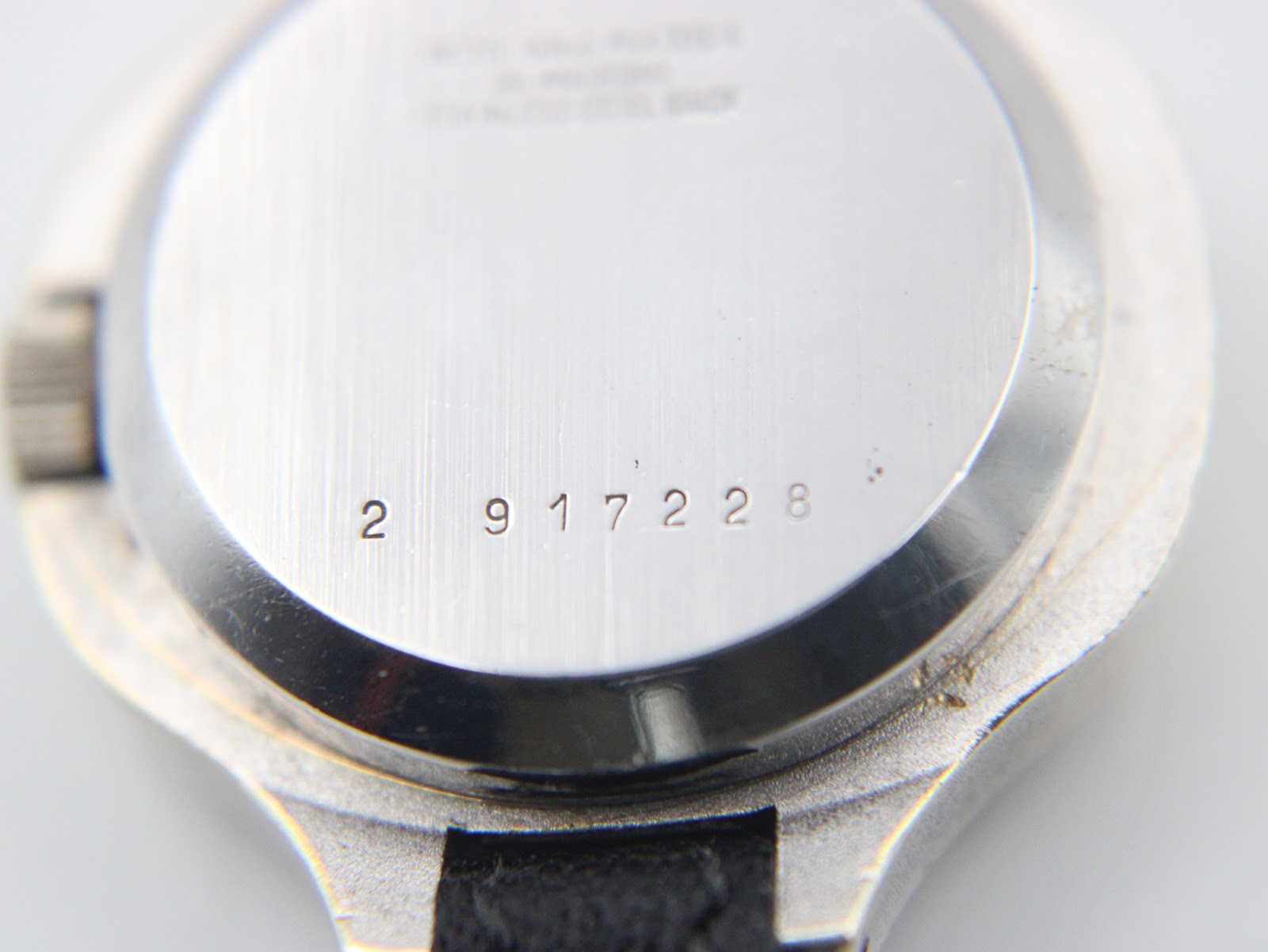 Close-up of the serial number "2 917228" engraved on the stainless steel case back.