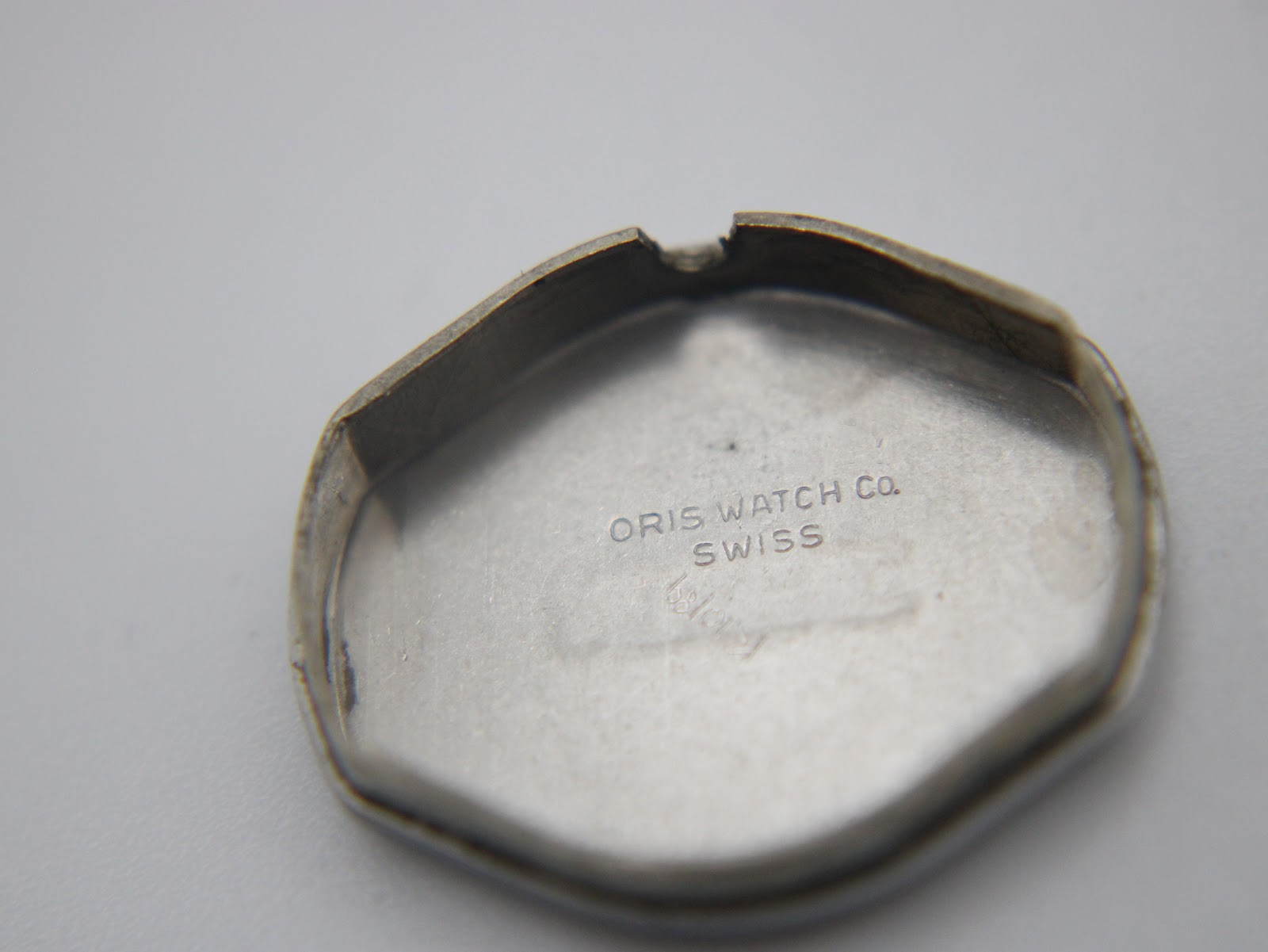 Inside of the stainless steel case back, marked "Oris Watch Co. Swiss".