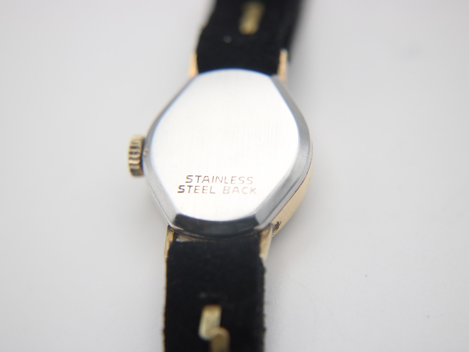 Close-up of the stainless steel case back of the Bifora watch, showing 'STAINLESS STEEL BACK' engraving.
