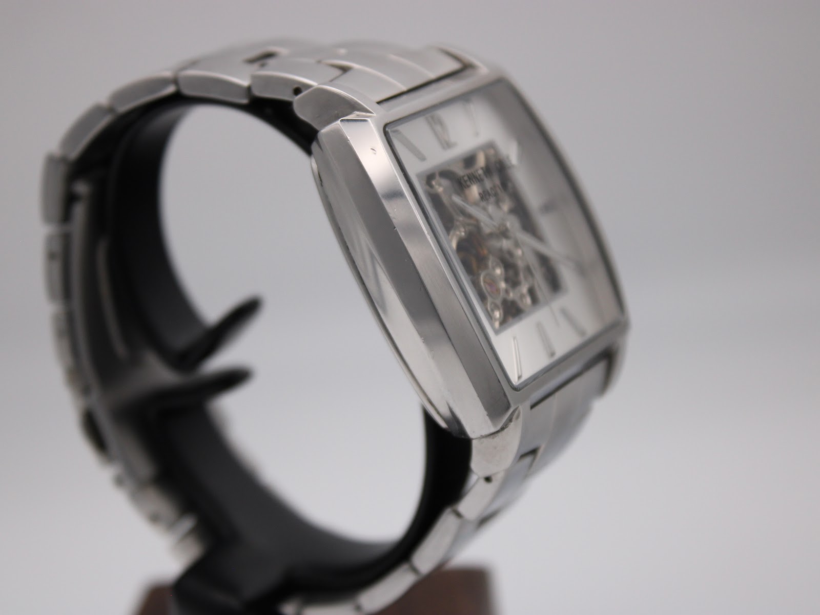 Opposite side quarter view of the watch, showing the brushed and polished finishes of the stainless steel case and bracelet.