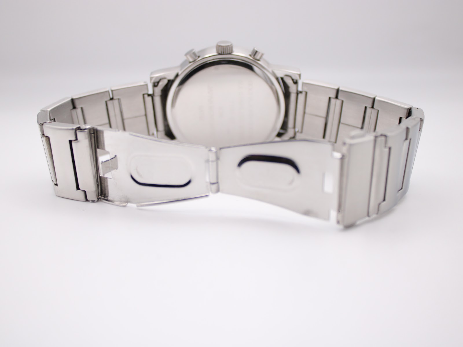 View of the open stainless steel butterfly clasp and bracelet links from the back.