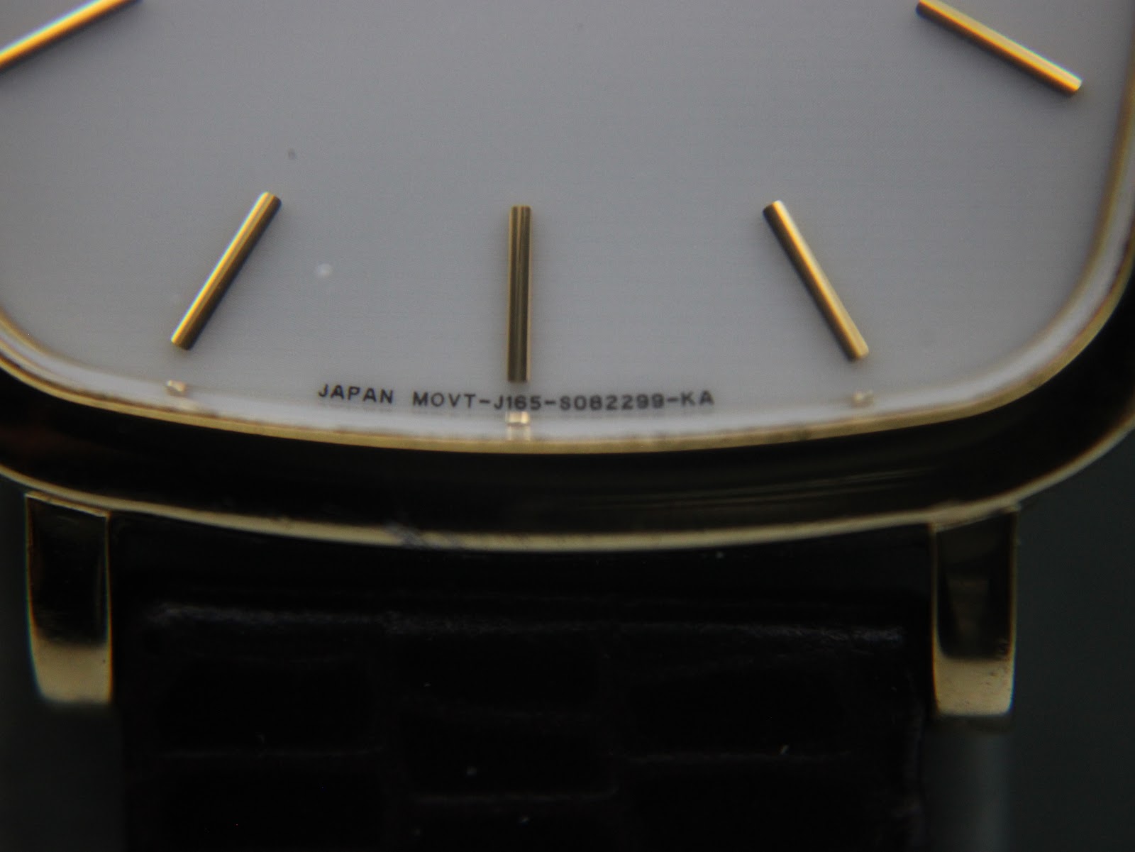 Extreme close-up of the dial bottom, showing "JAPAN MOVT-J165-S082298-KA" text.