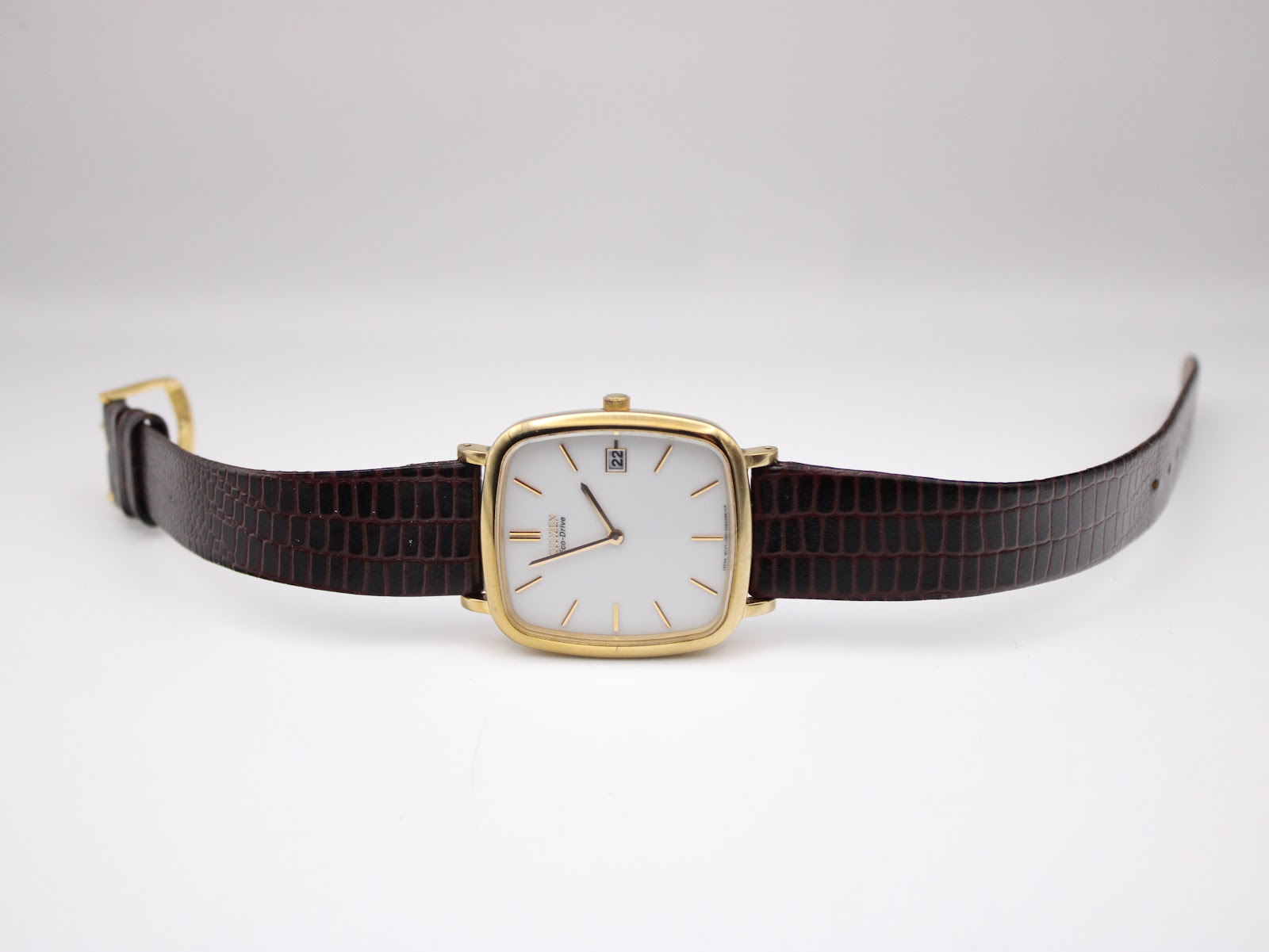 Full view of the Citizen watch laid flat, showing the brown crocodile-grain leather strap and buckle.