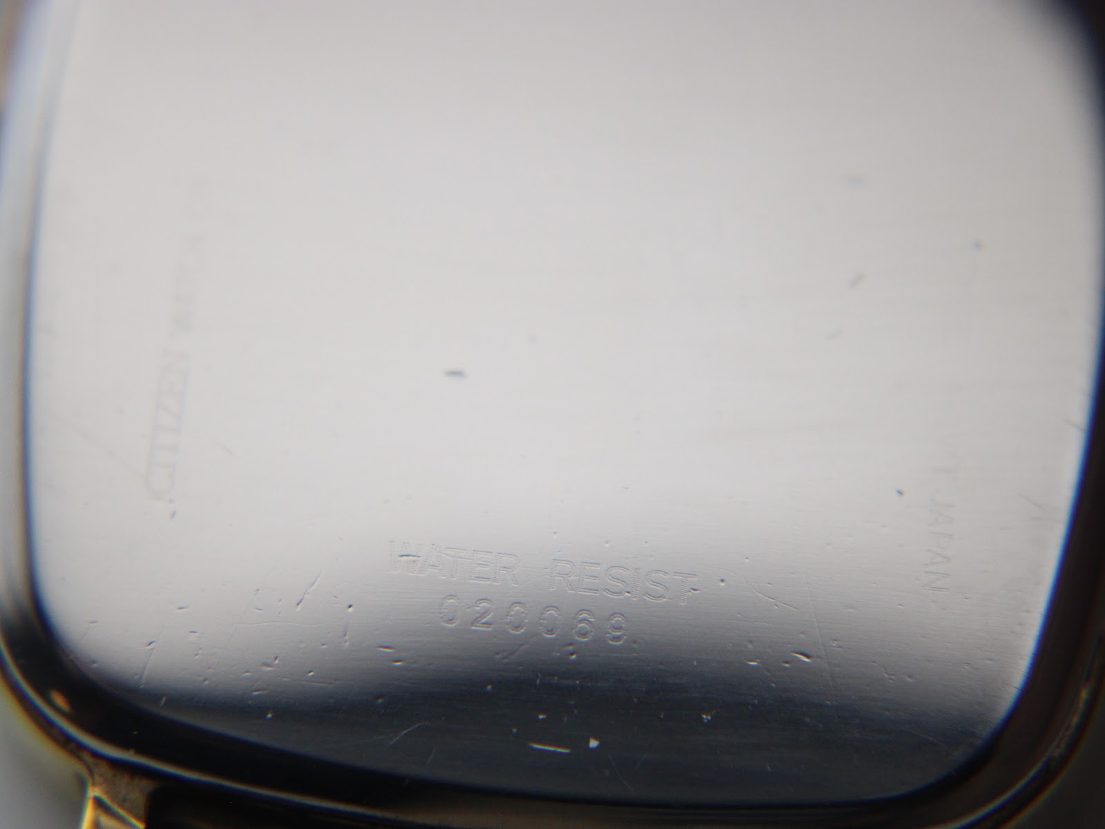 Close-up of the polished case back, with "WATER RESIST" and "020069" engraving partially visible.