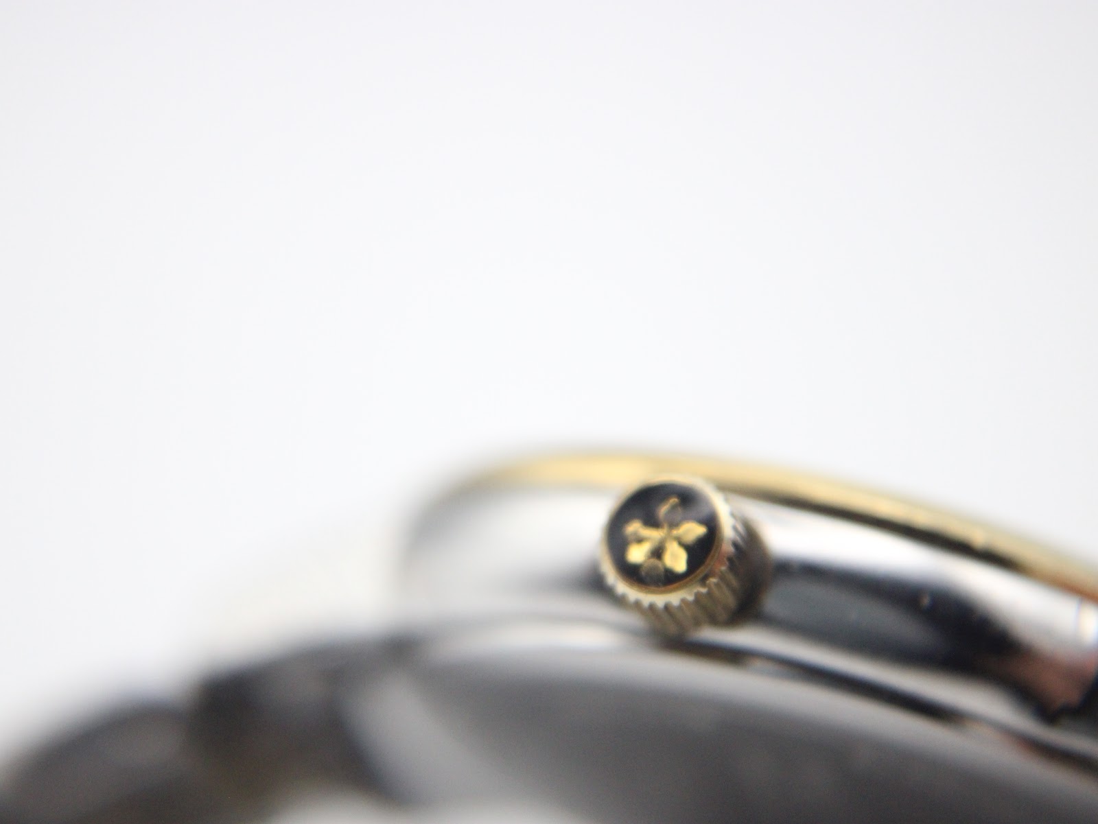 Macro shot of the gold-tone crown with the Dreyfuss emblem.