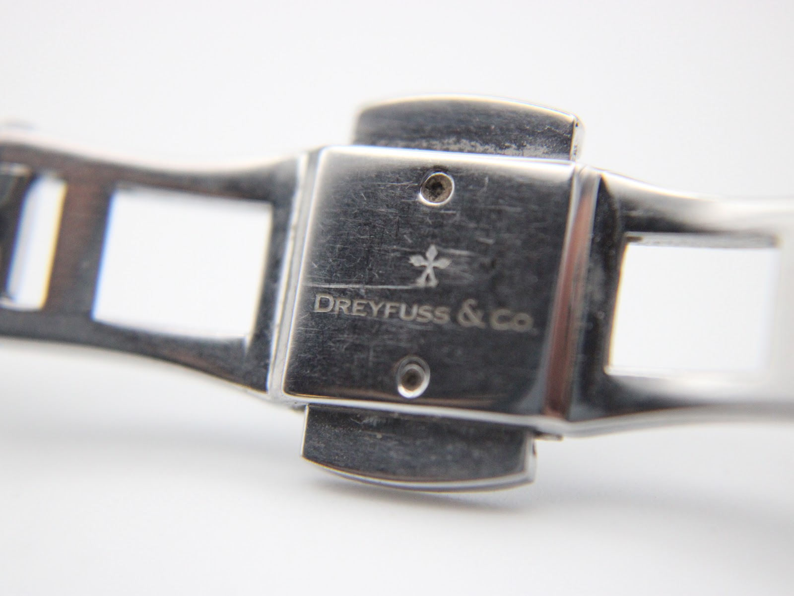 Close-up of the two-tone stainless steel bracelet clasp, signed "DREYFUSS & Co.".